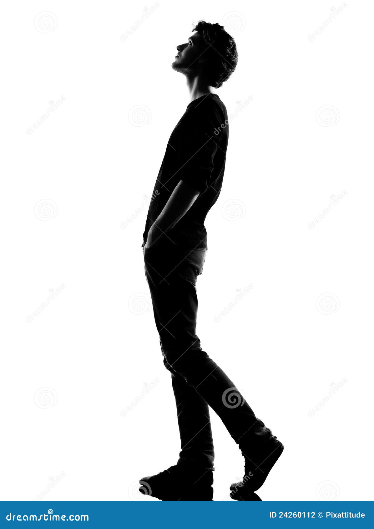 young man silhouette walking looking up