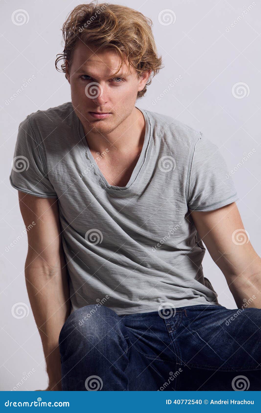 blonde african american man with blue eyes looking at camera