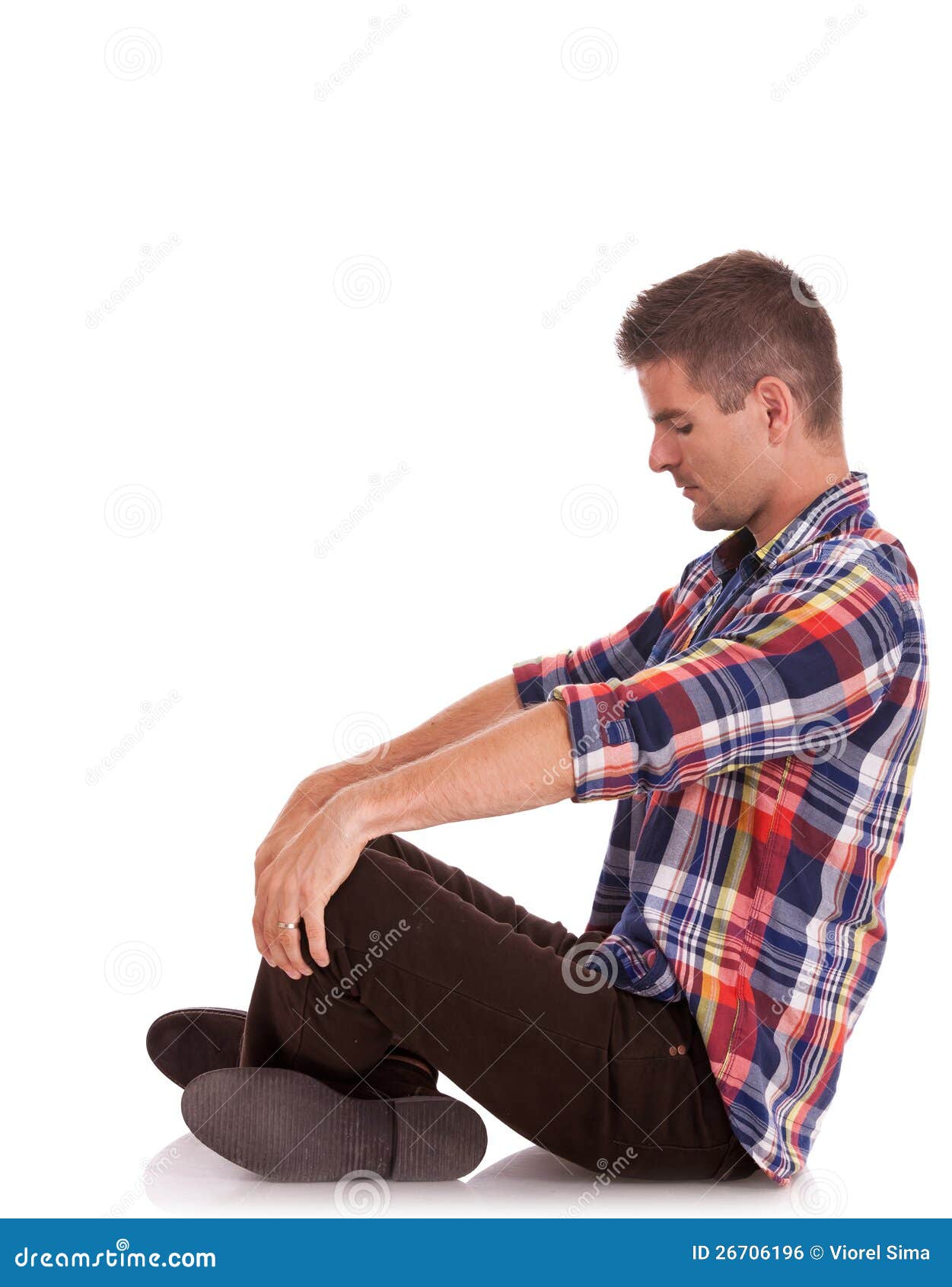 Young Man Sitting Looking Down Stock Photo - Image: 26706196