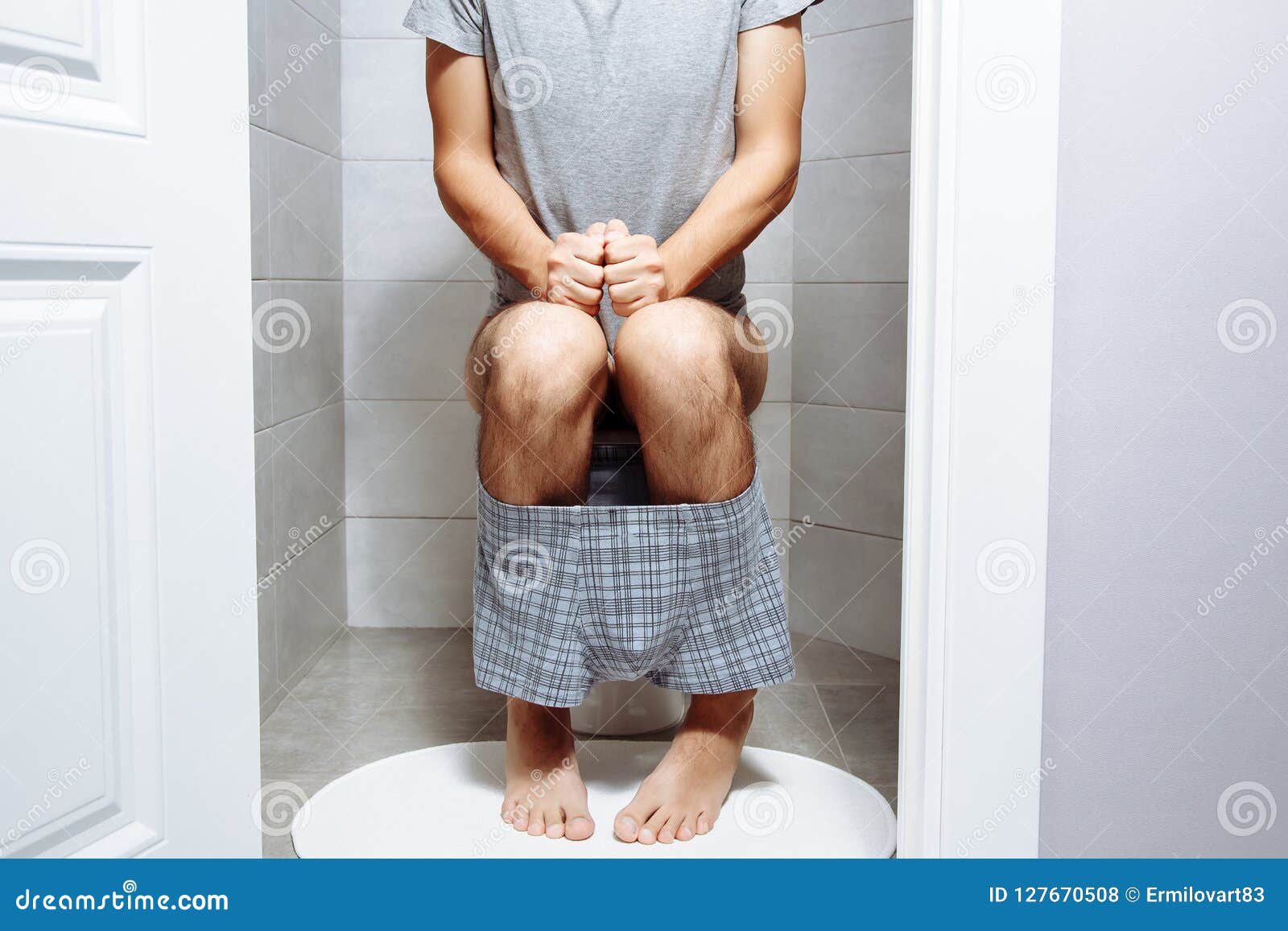 Young Man Sitting on Toilet Bowl at Home Stock Photo Image of bowl