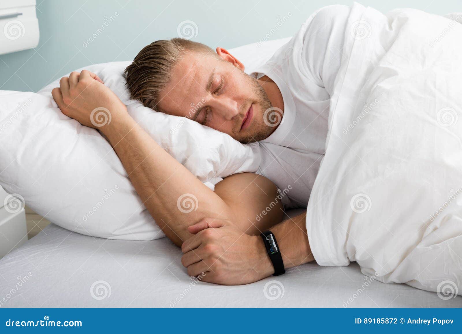 young man sleeping on bed