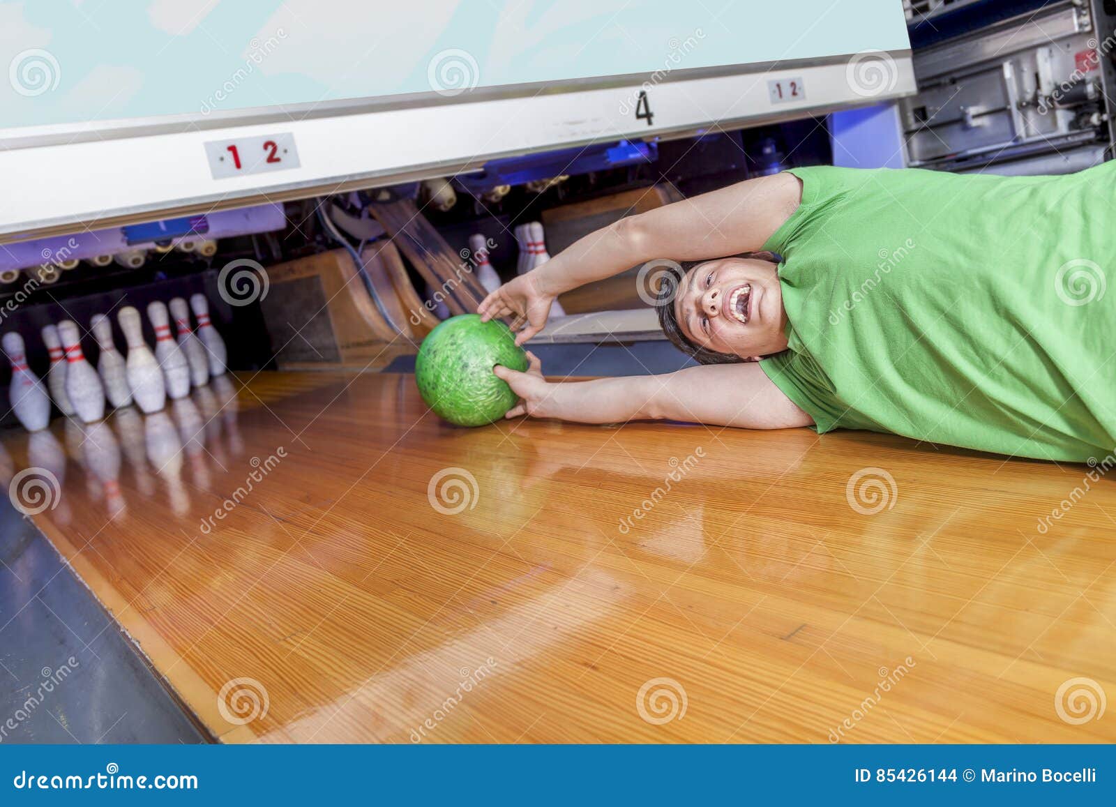 Young Man Sliding Down a Bowling Alley Stock Photo Image of mishap