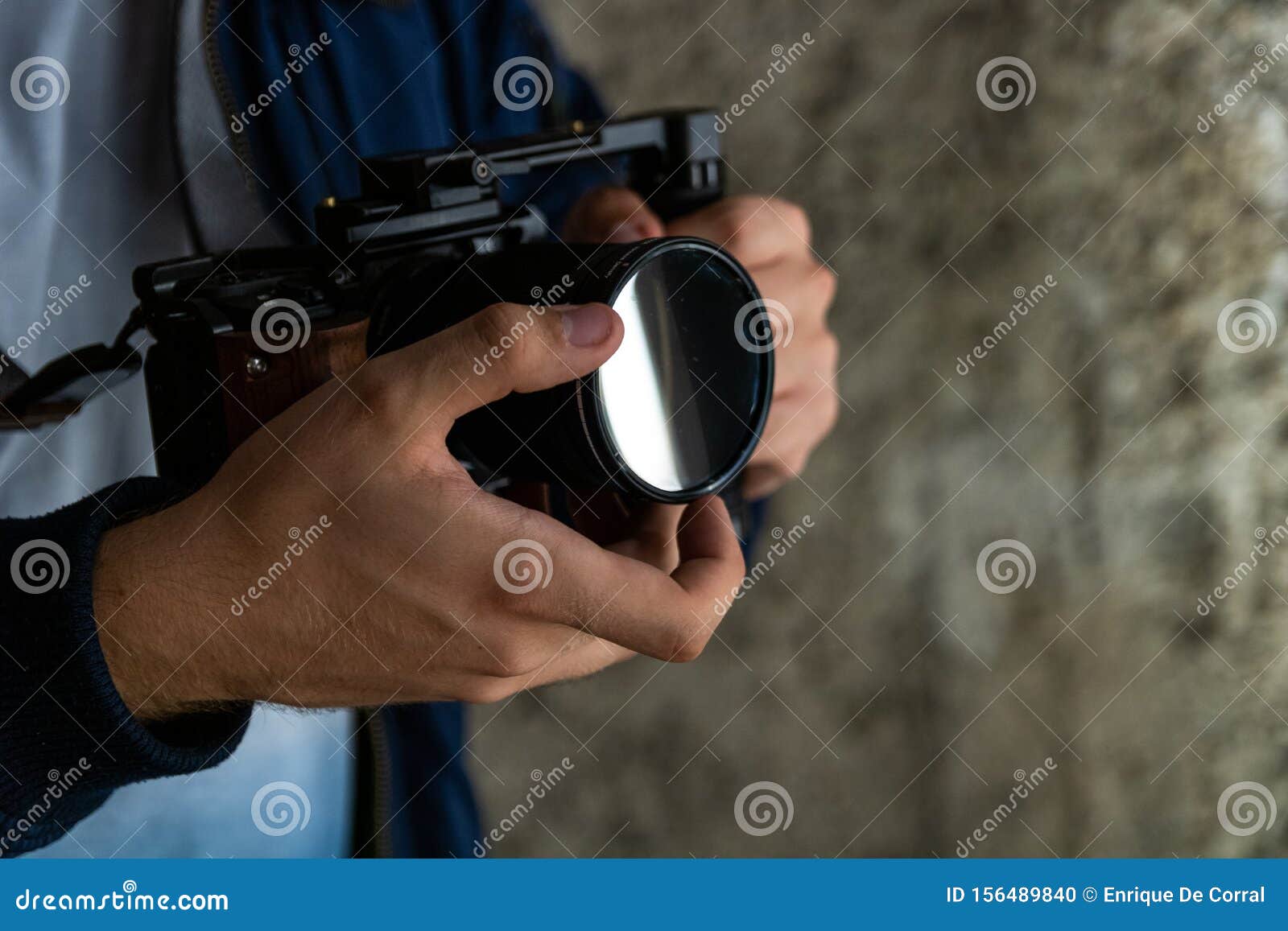 Young Man Sliding His Variable ND Filter on Camera. Finding a Good