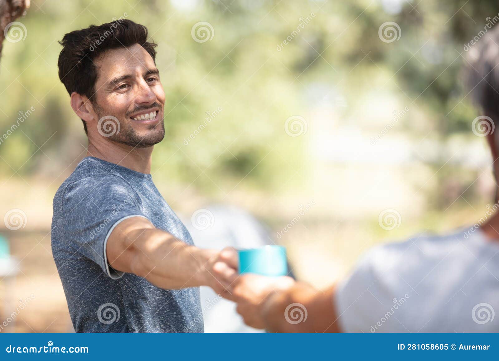 young man smiling at campsite