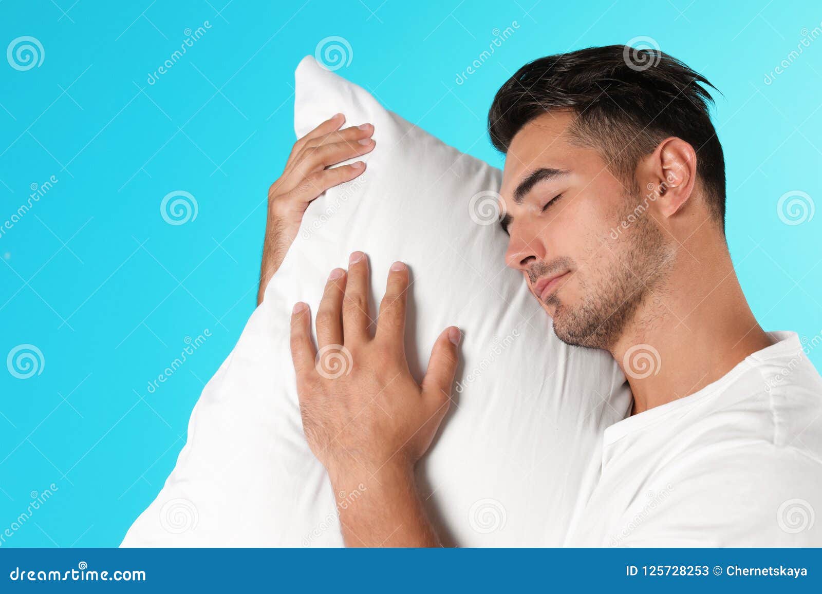 Young man with soft pillow stock image. Image of hugging 125728253