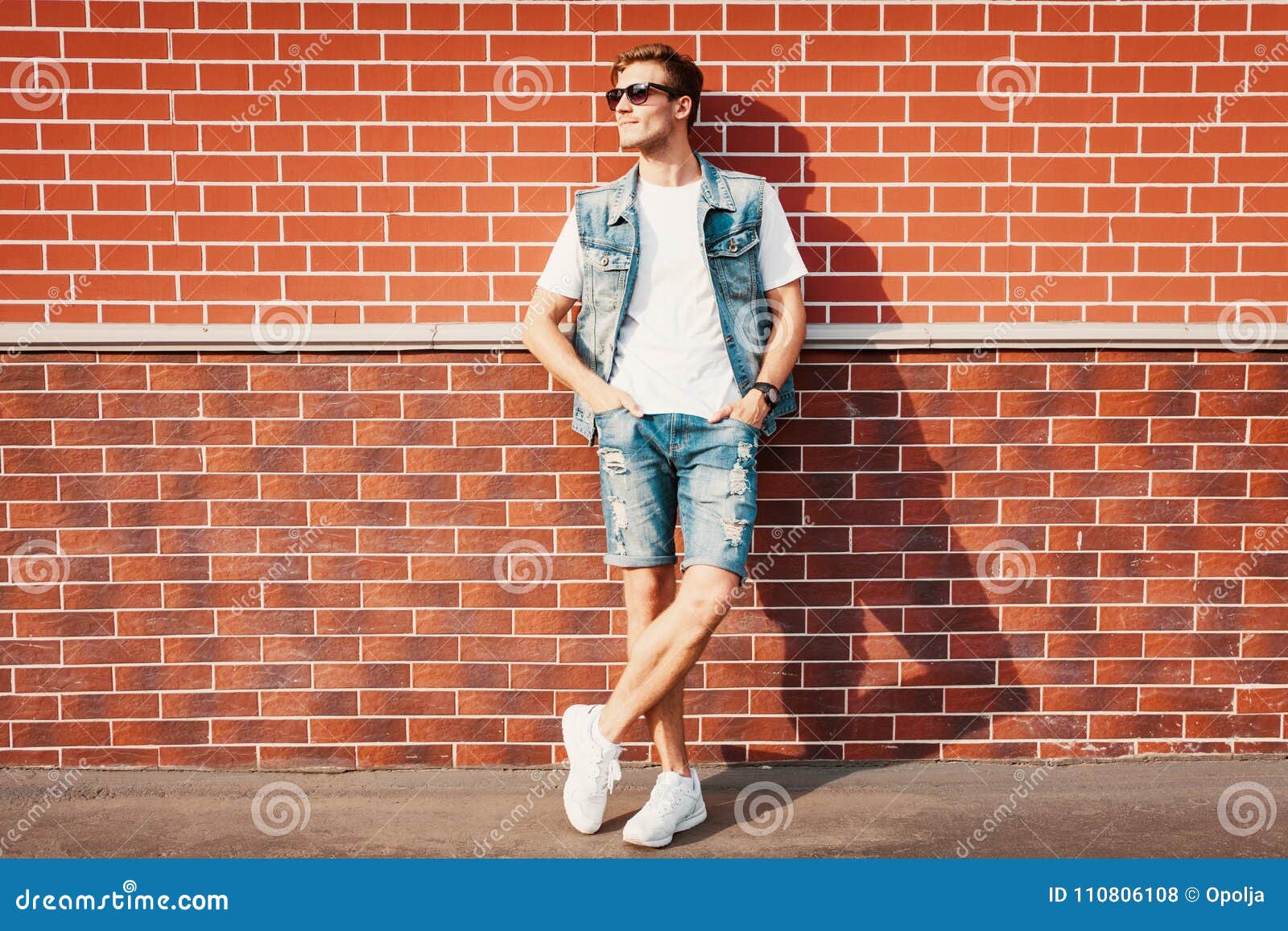 Young Man Standing Against a Brick Wall Stock Photo - Image of jacket ...