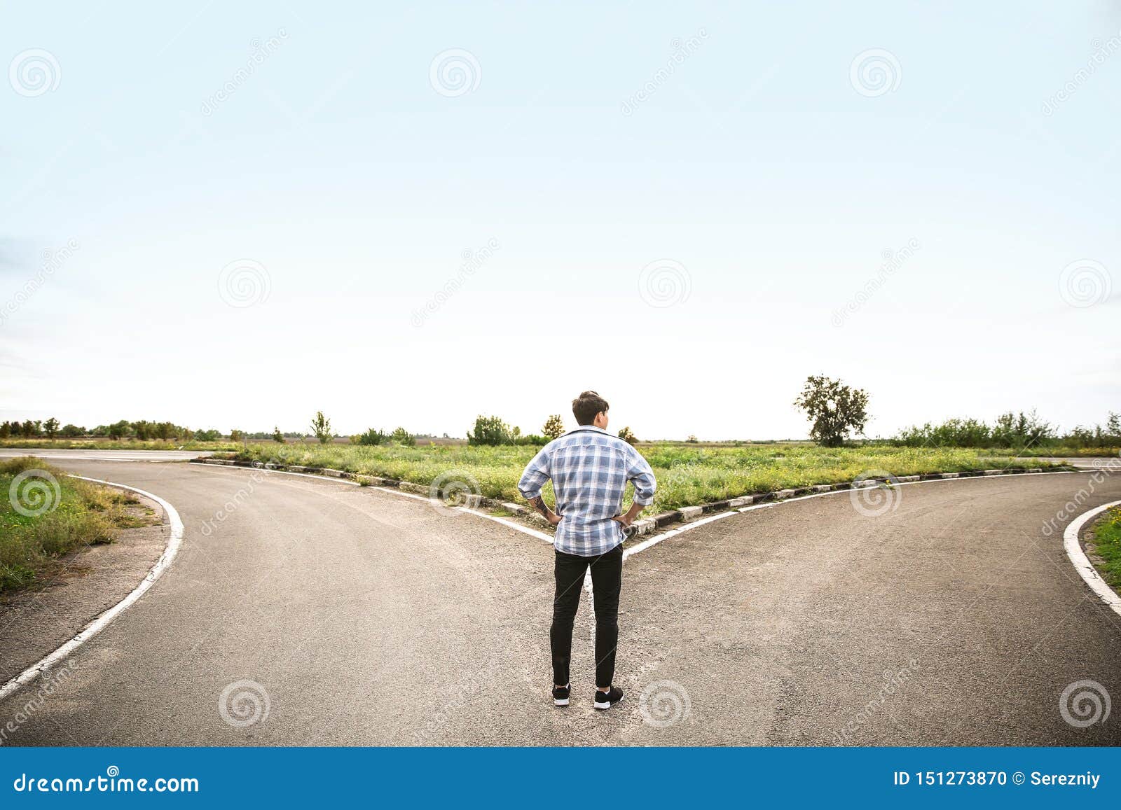 young man standing at crossroads. concept of choice