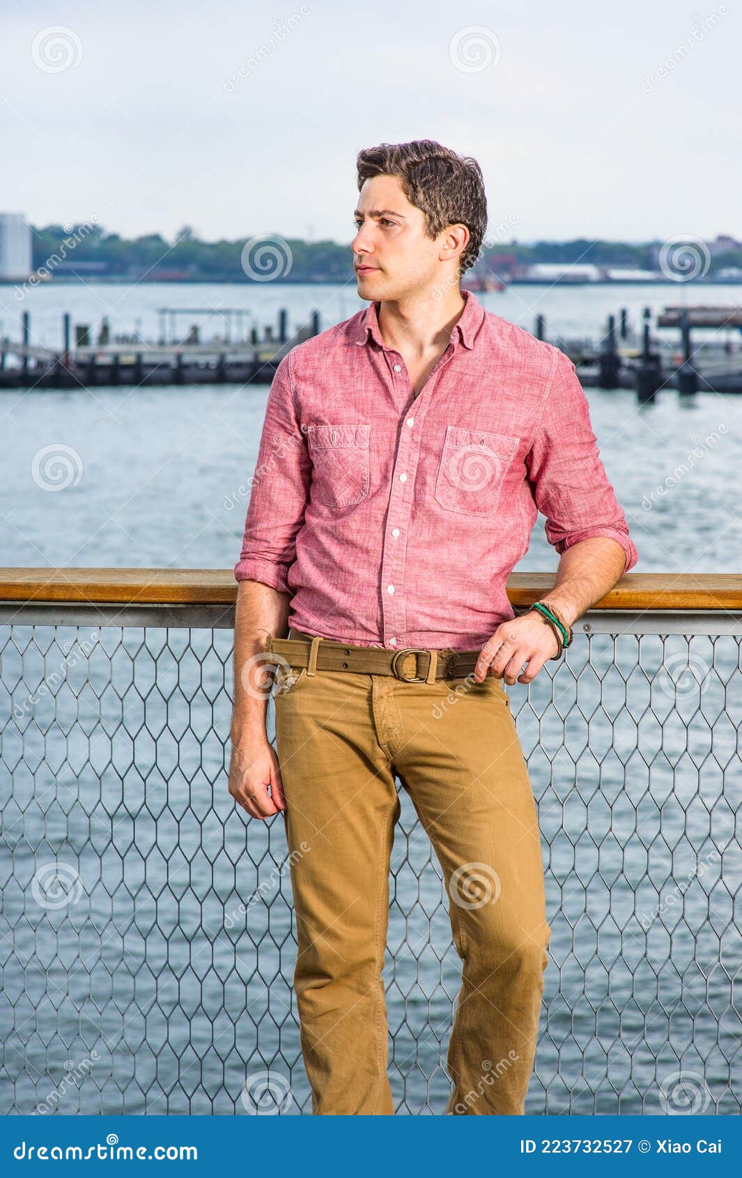 Relaxed Casual Man In Jeans And Red Tshirt Walking And Looking At