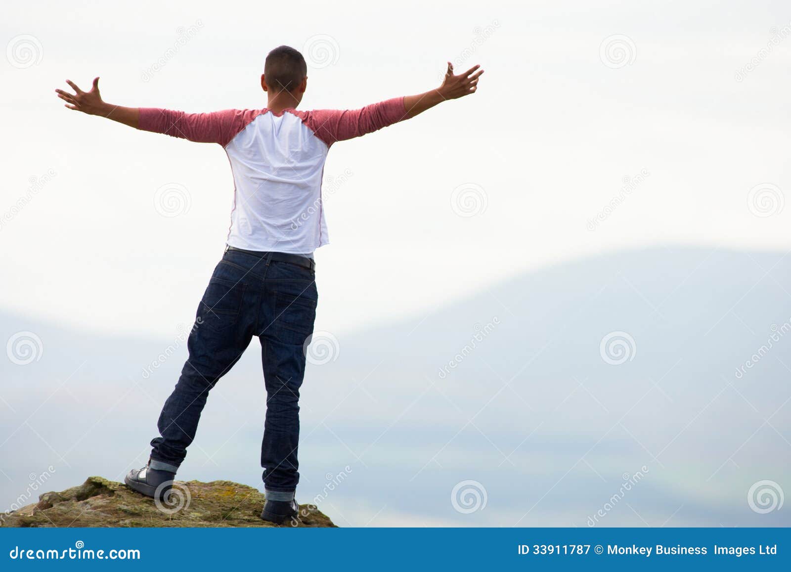 Young Man Standing on Rock stock image. Image of mixed 33911787