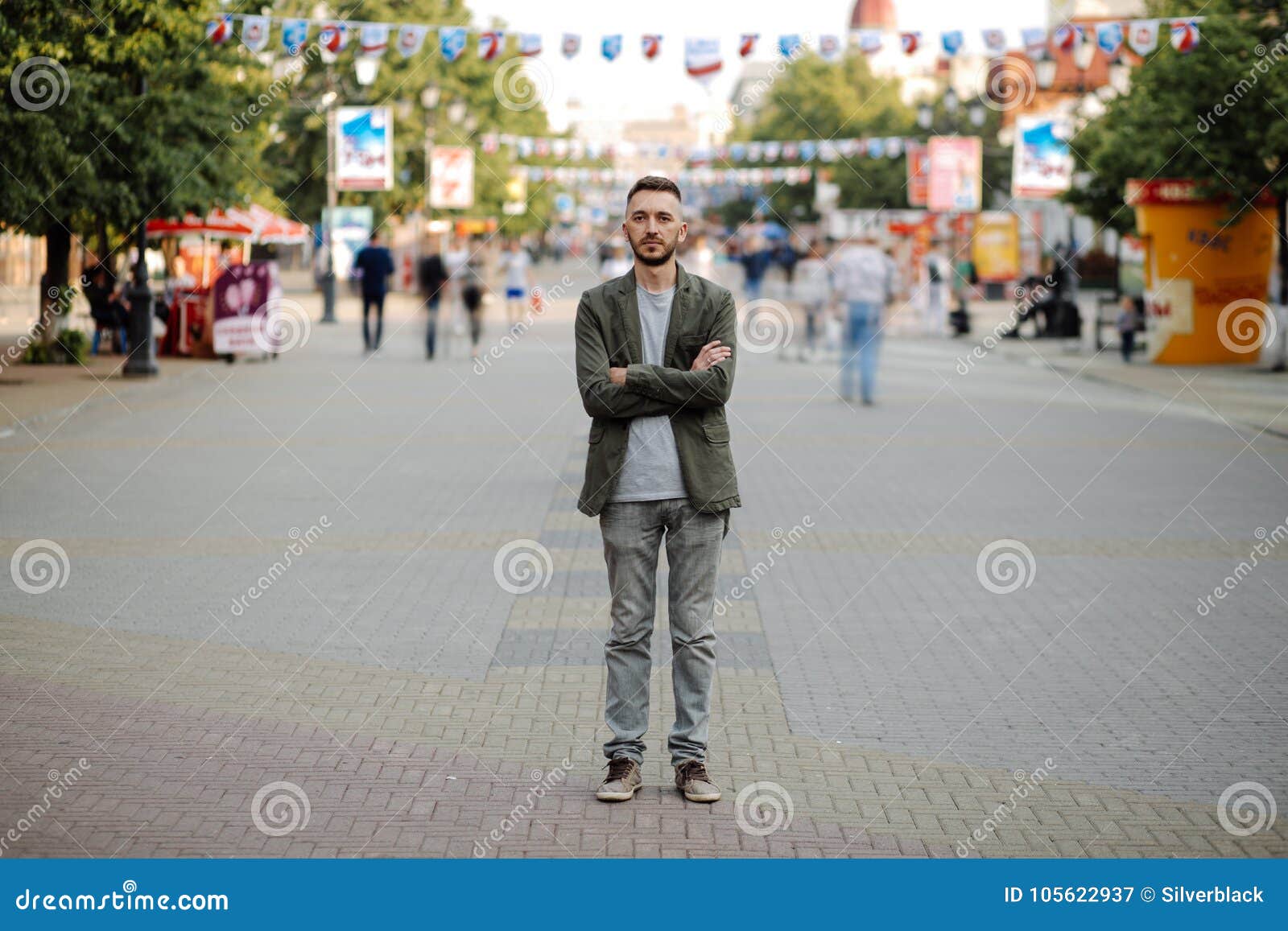 Young Man Standing Still at Sidewalk with People Moving Around Stock Image Image of think