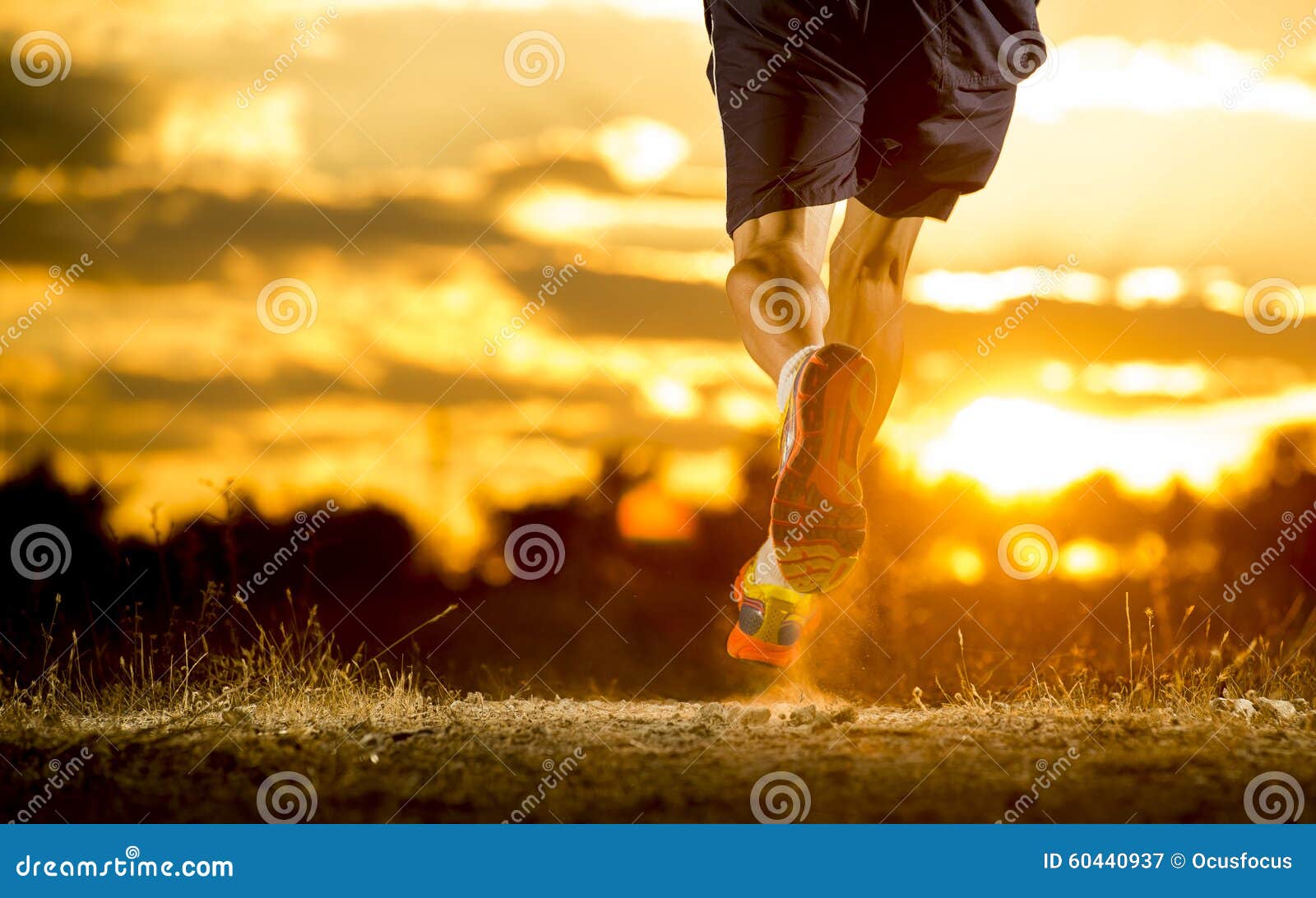 young man strong legs off trail running at amazing summer sunset in sport and healthy lifestyle