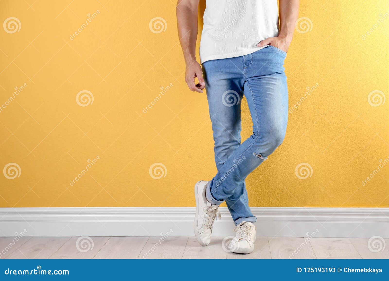 Young Man in Stylish Jeans Near Color Wall Stock Image - Image of ...