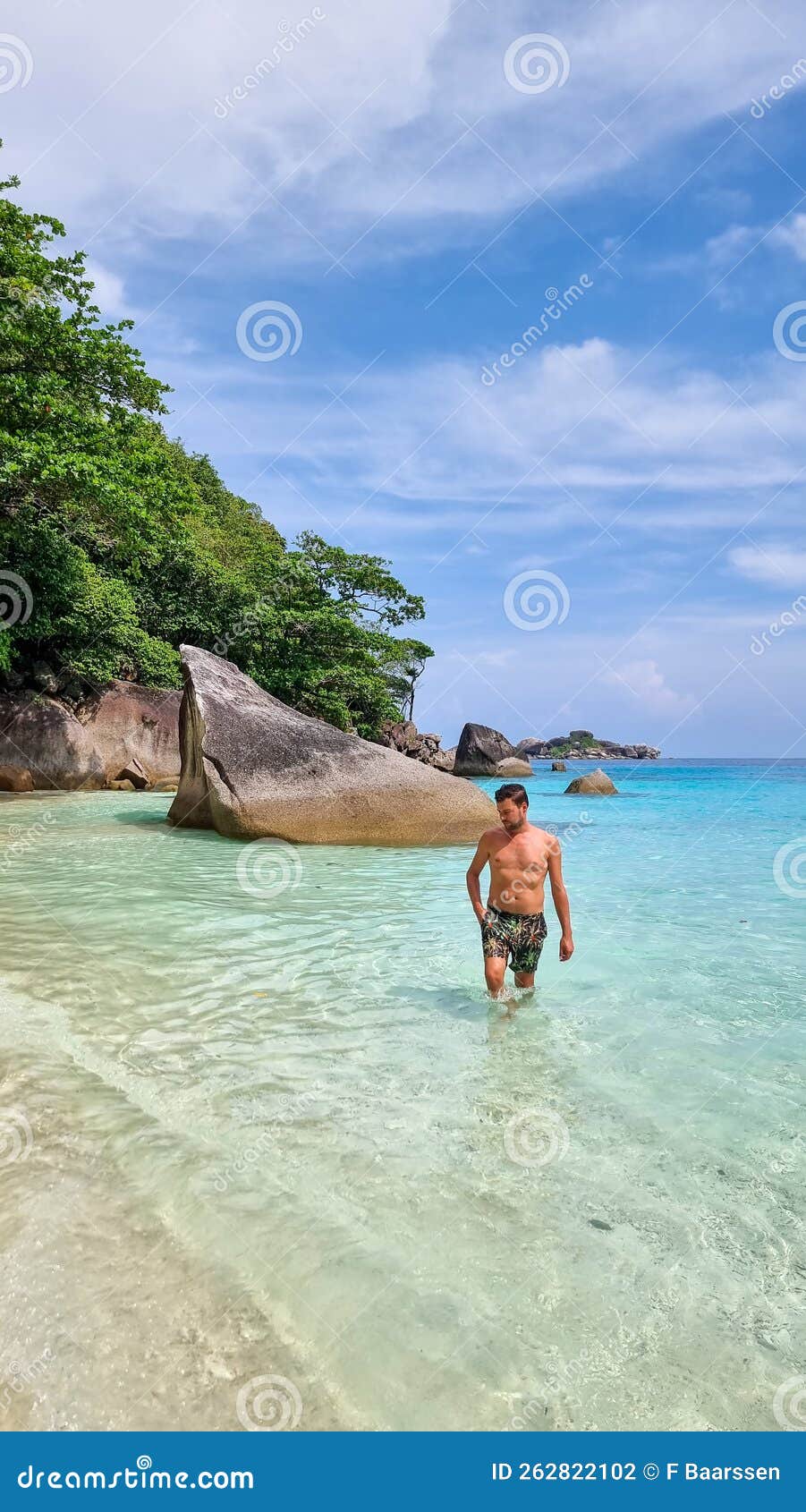 young men in swimshort at the beach of the similan islands in thailand