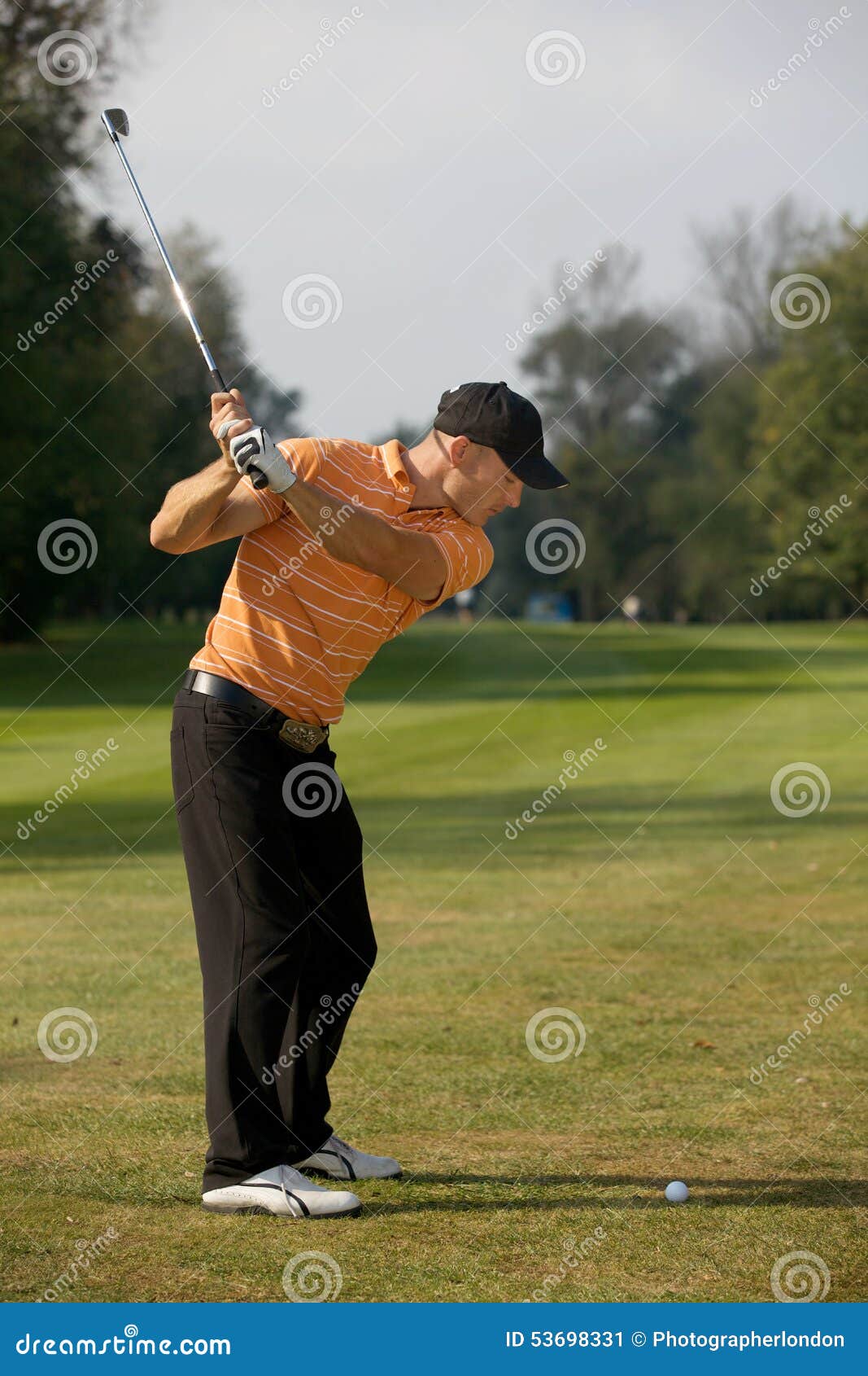 Young Man Swinging Golf Club Stock Image - Image of sport, foreground ...