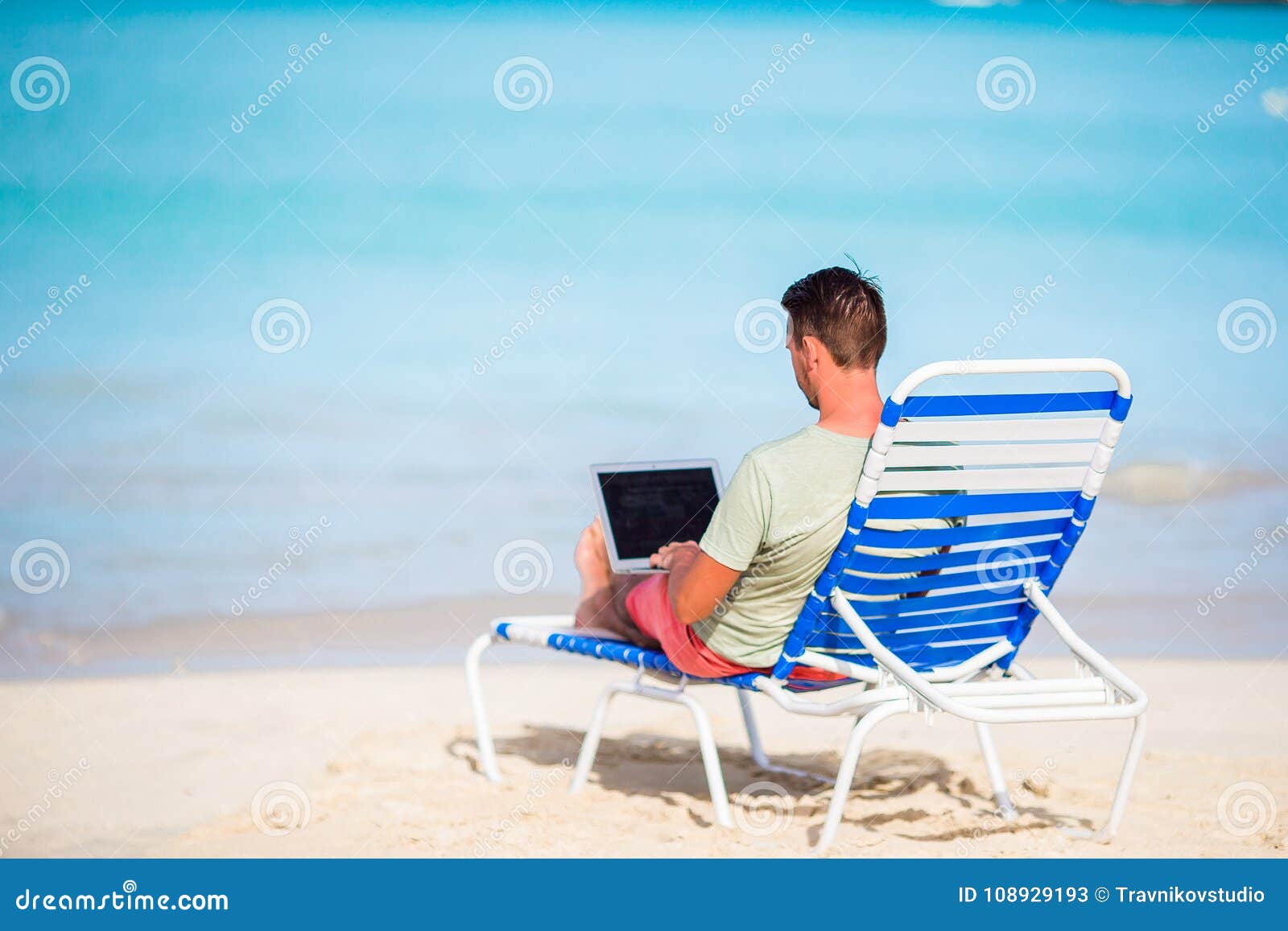 Young Man with Laptop on Tropical Caribbean Beach. Man Sitting on the ...