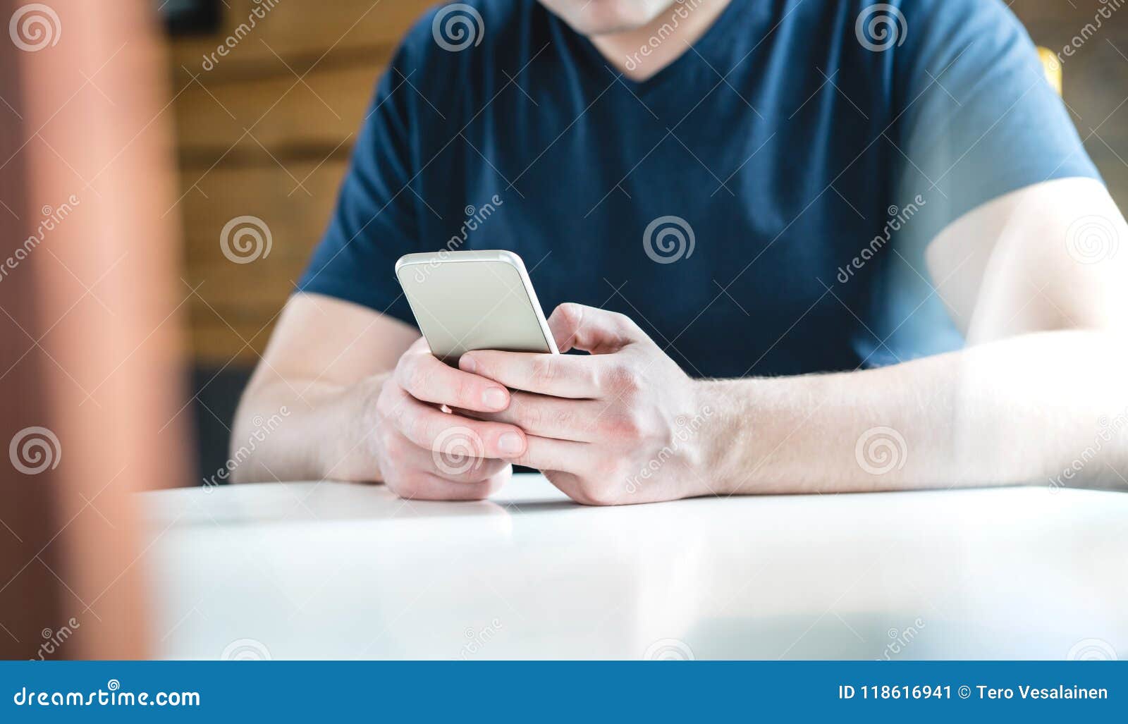 young man texting with smartphone. guy using mobile phone.