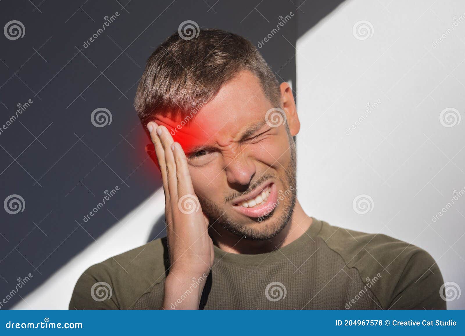 man touching his temple and having strong tension headache. cluster headache