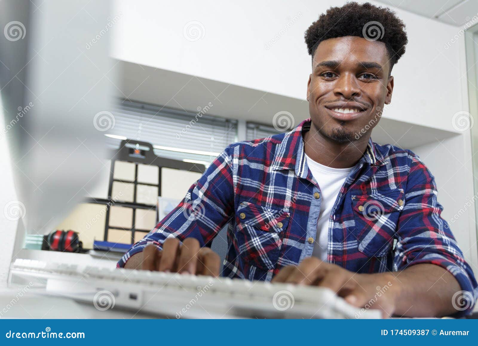 Young Man Typing on Computer Keyboard in Office Stock Image Image of