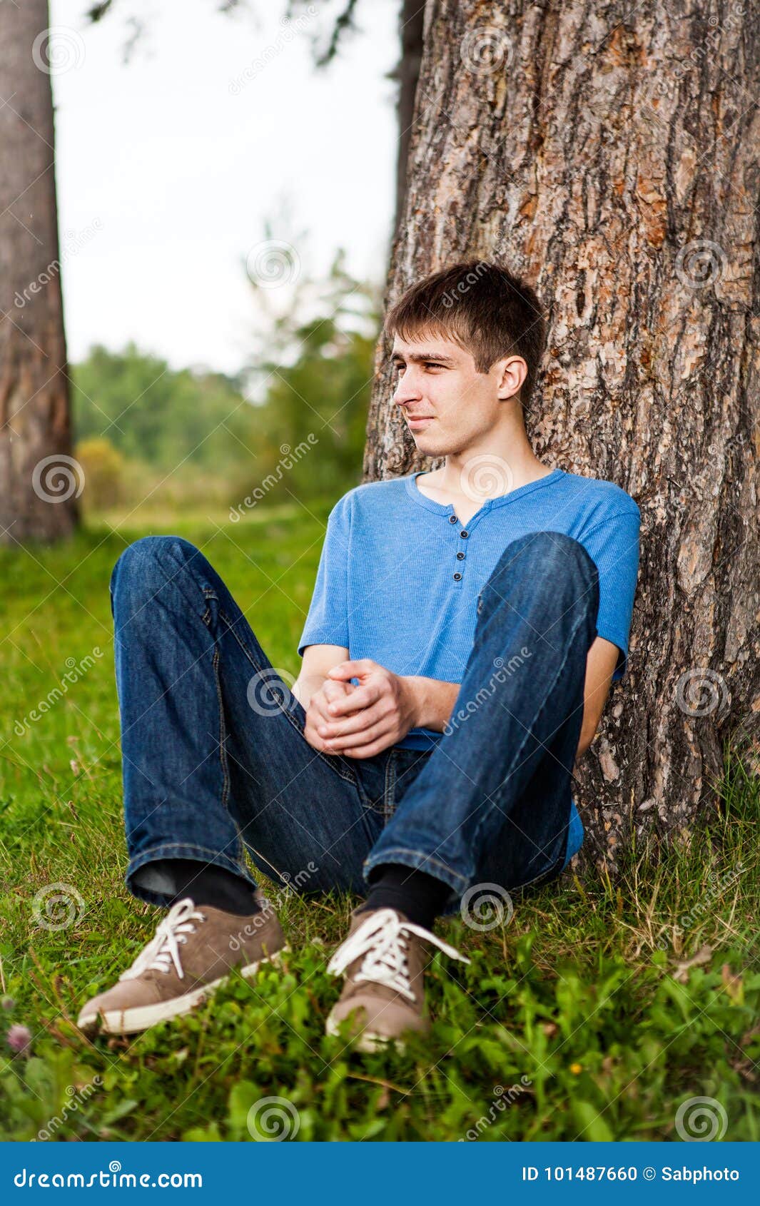 Young Man Under Tree stock photo. Image of loneliness - 101487660