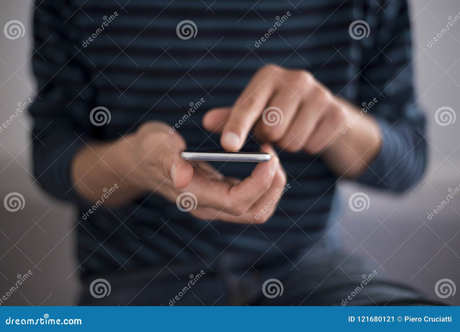 young man using touchscreen smartphone. concept for using technology, shopping online, using mobile apps, texting, phone addiction