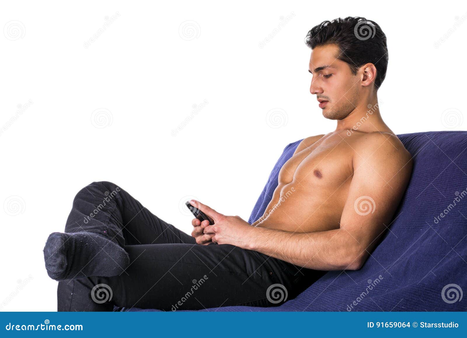 Young Man Using Cell Phone Sitting on Couch Stock Photo Image of