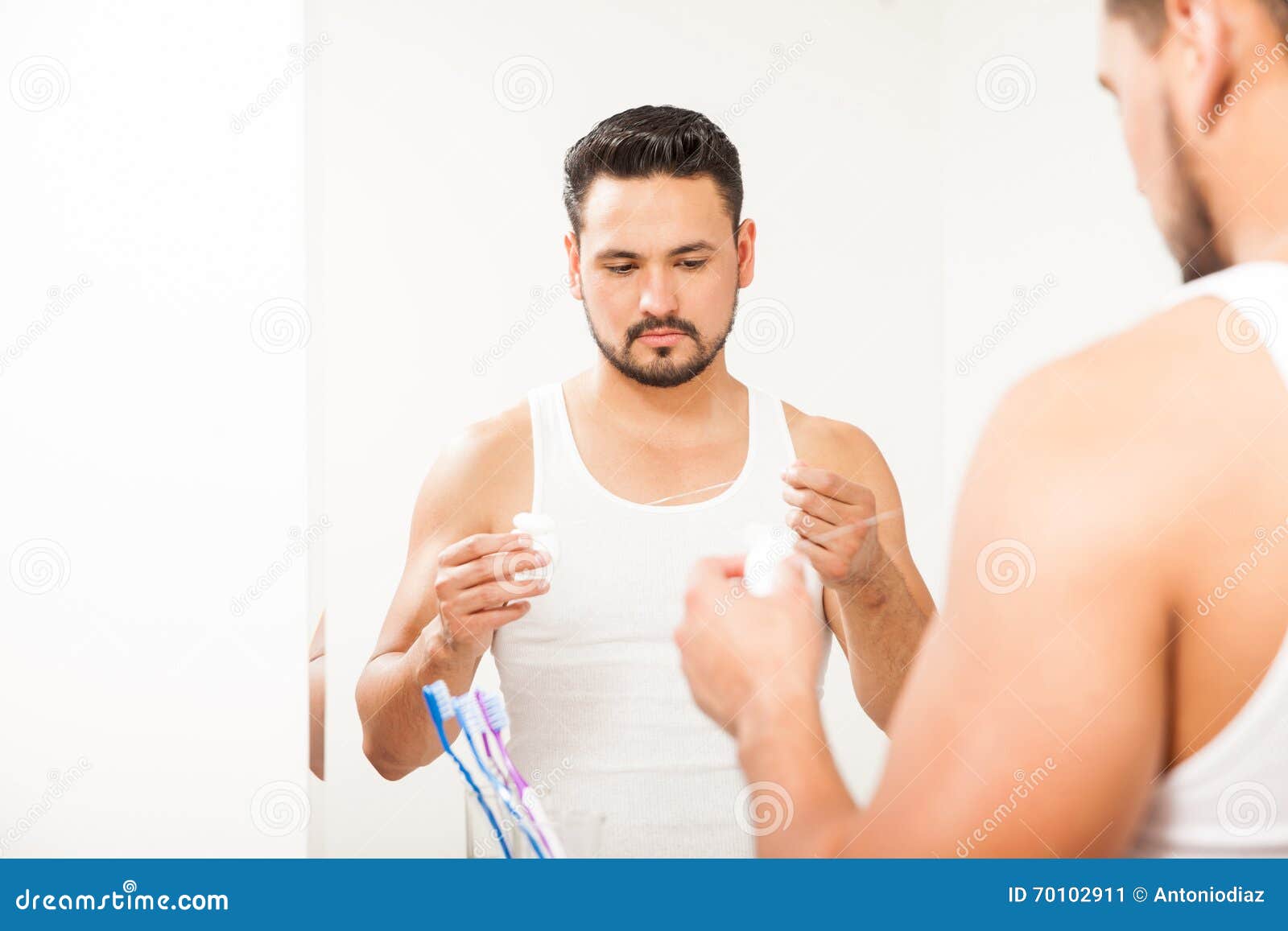 Young Man Using Dental Floss in the Bathroom Stock Image Image of
