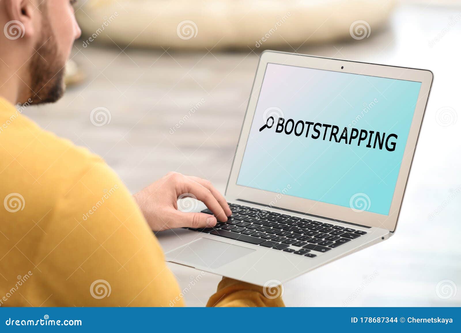 young man using laptop at home. bootstrap button