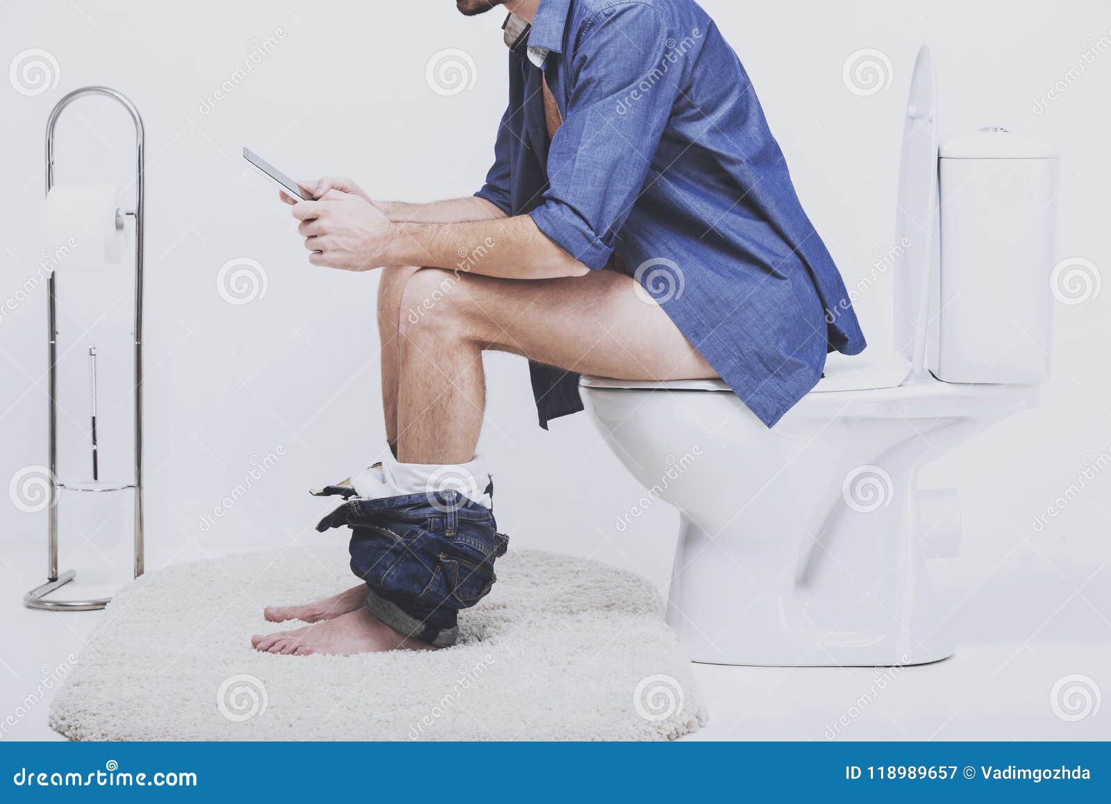 Young Man Using Modern Laptop In Toilet Stock Photo 