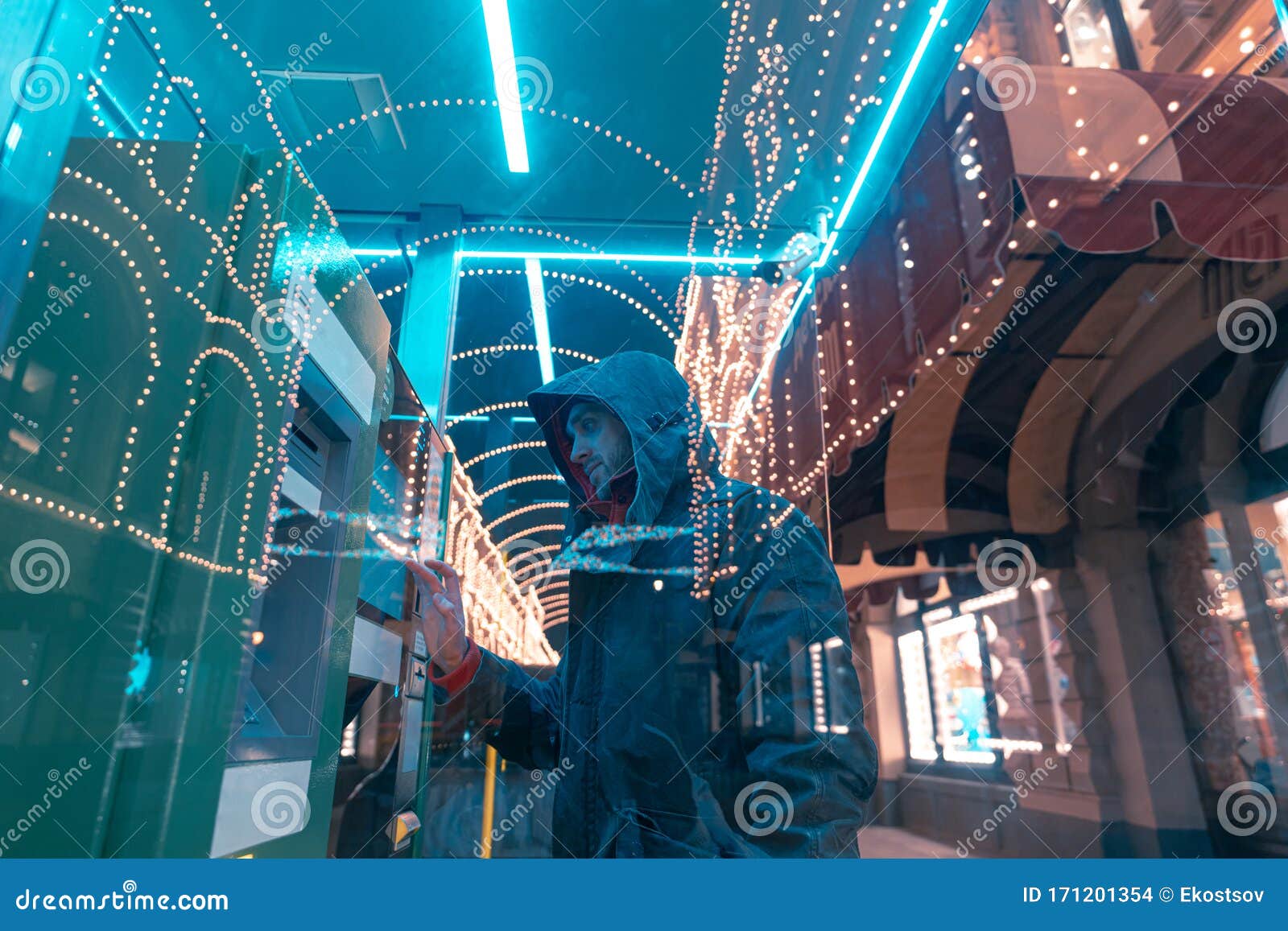young man using a touching interective display on self service machine. interactive technologies.