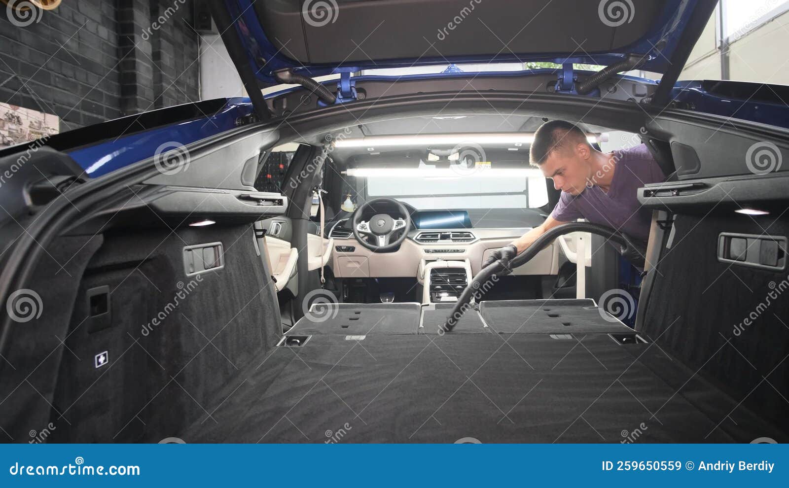 A Young Man Vacuums the Trunk of a Car. Stock Image Image of care