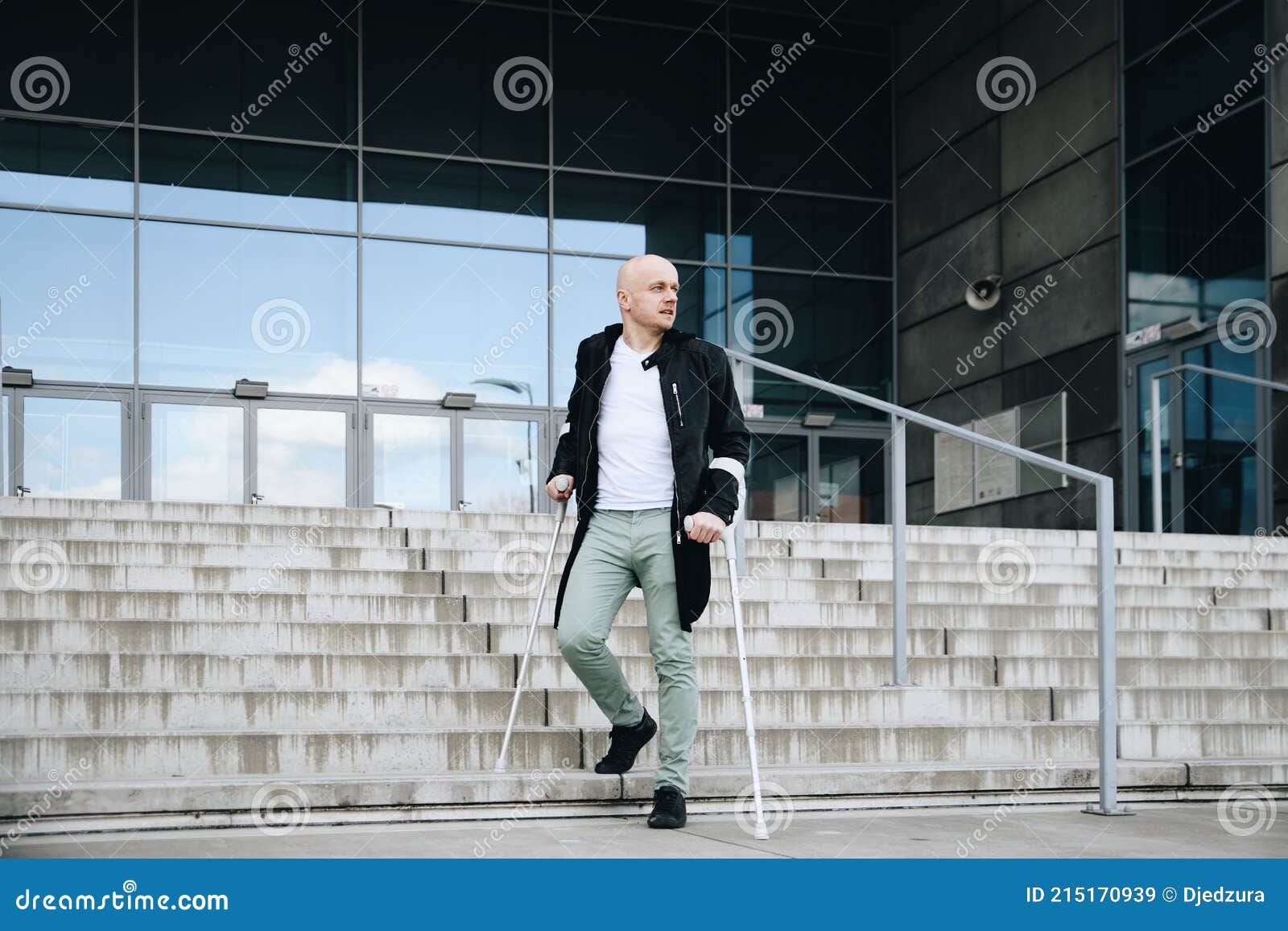 Young Man Walks on Crutches on the Stairs. Stock Image Image of
