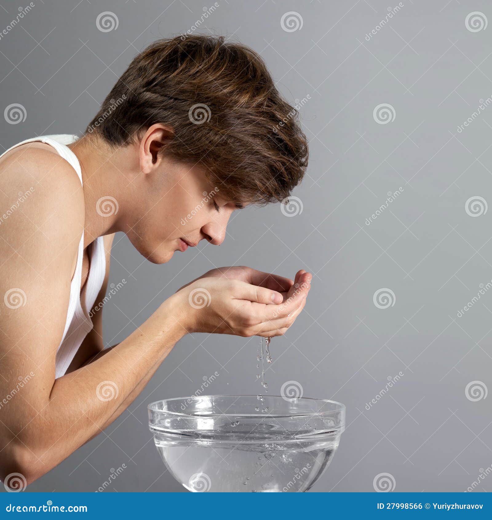 Young man washing his face stock photo. Image of care 27998566