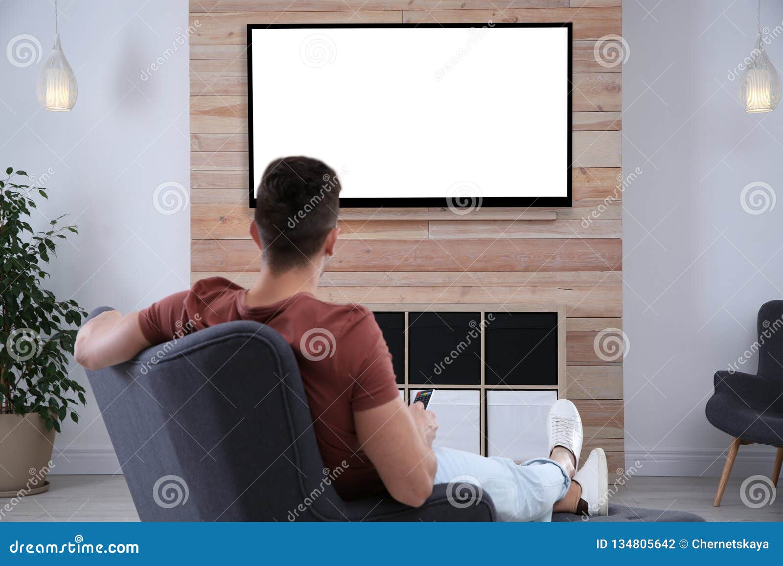 Young Man Watching Tv In Armchair Stock Photo Image Of