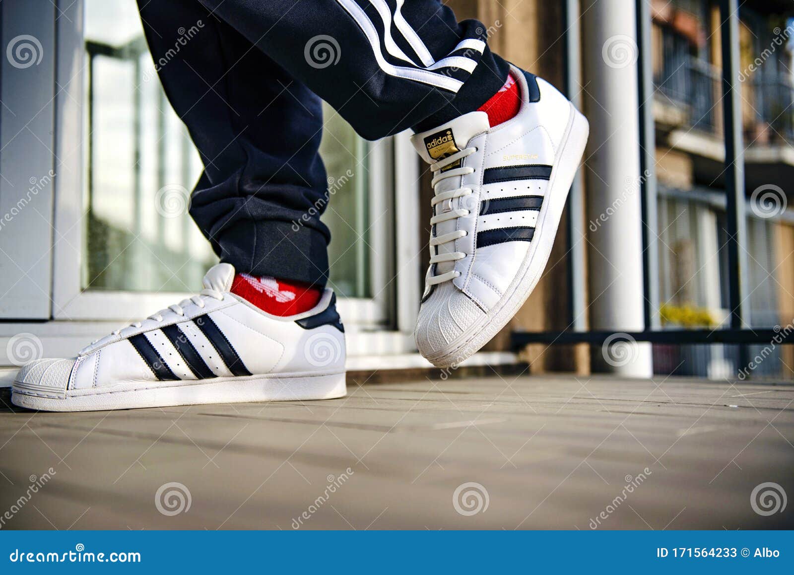 man wearing adidas superstar