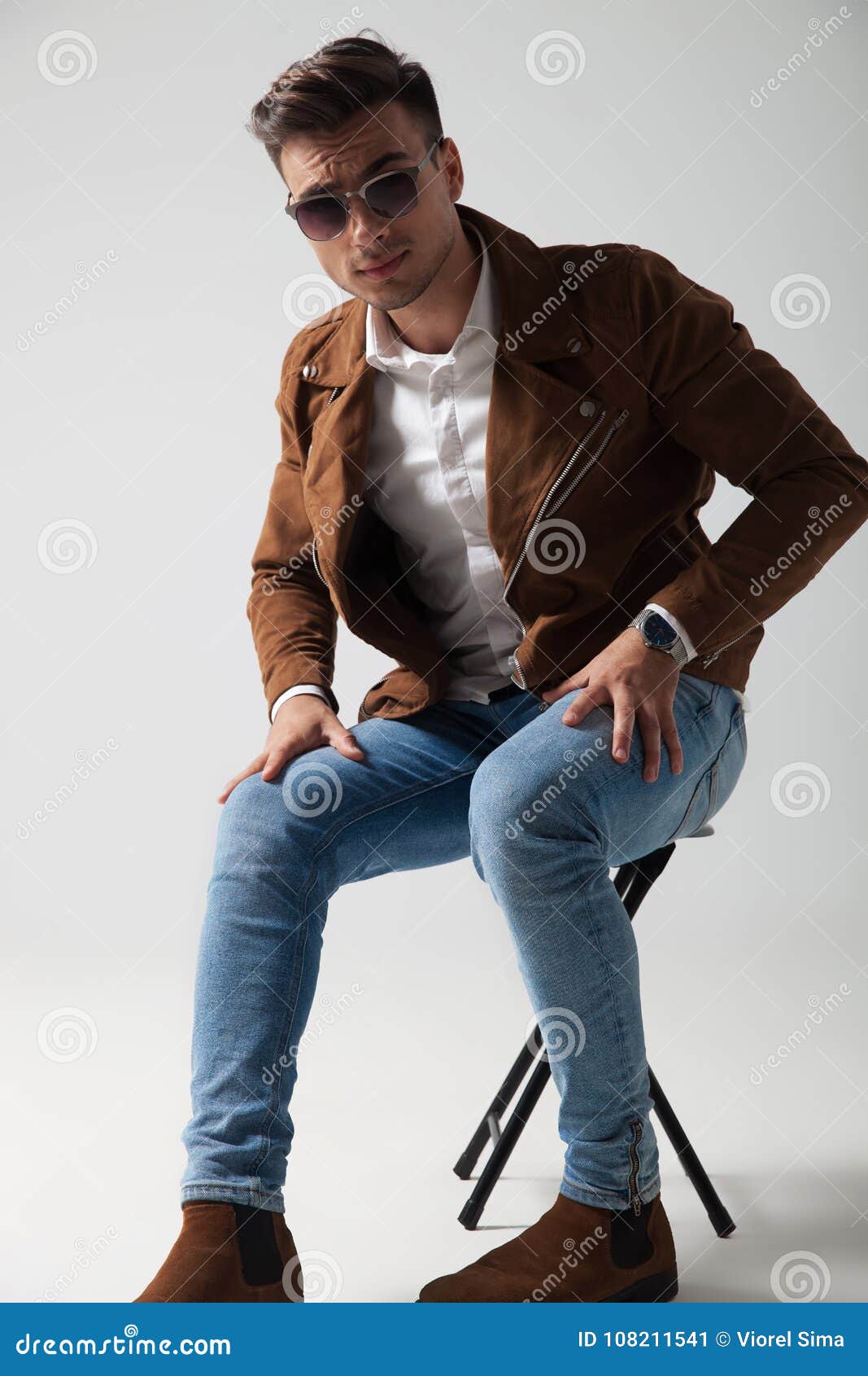 Young Man Wearing Sunglasses and Leather Jacket Sitting Stock Image ...