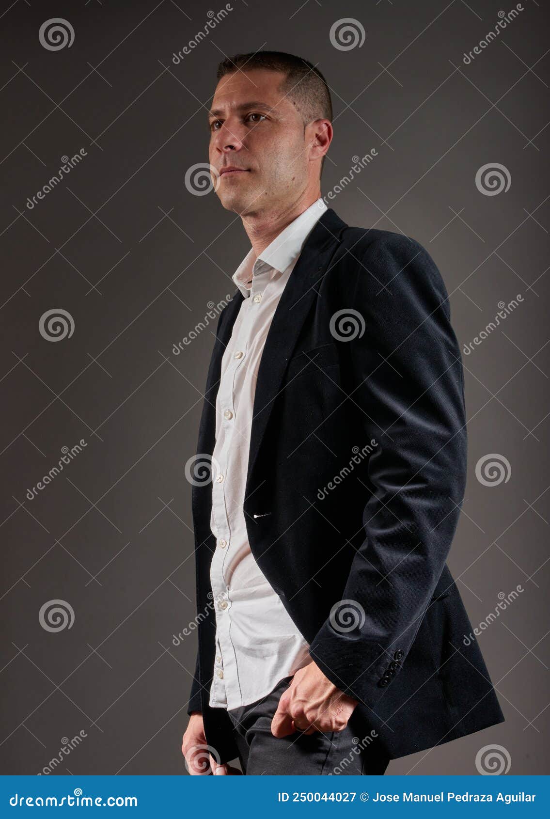 A Young Man Wearing a White Shirt and a Black Jacket Stock Image