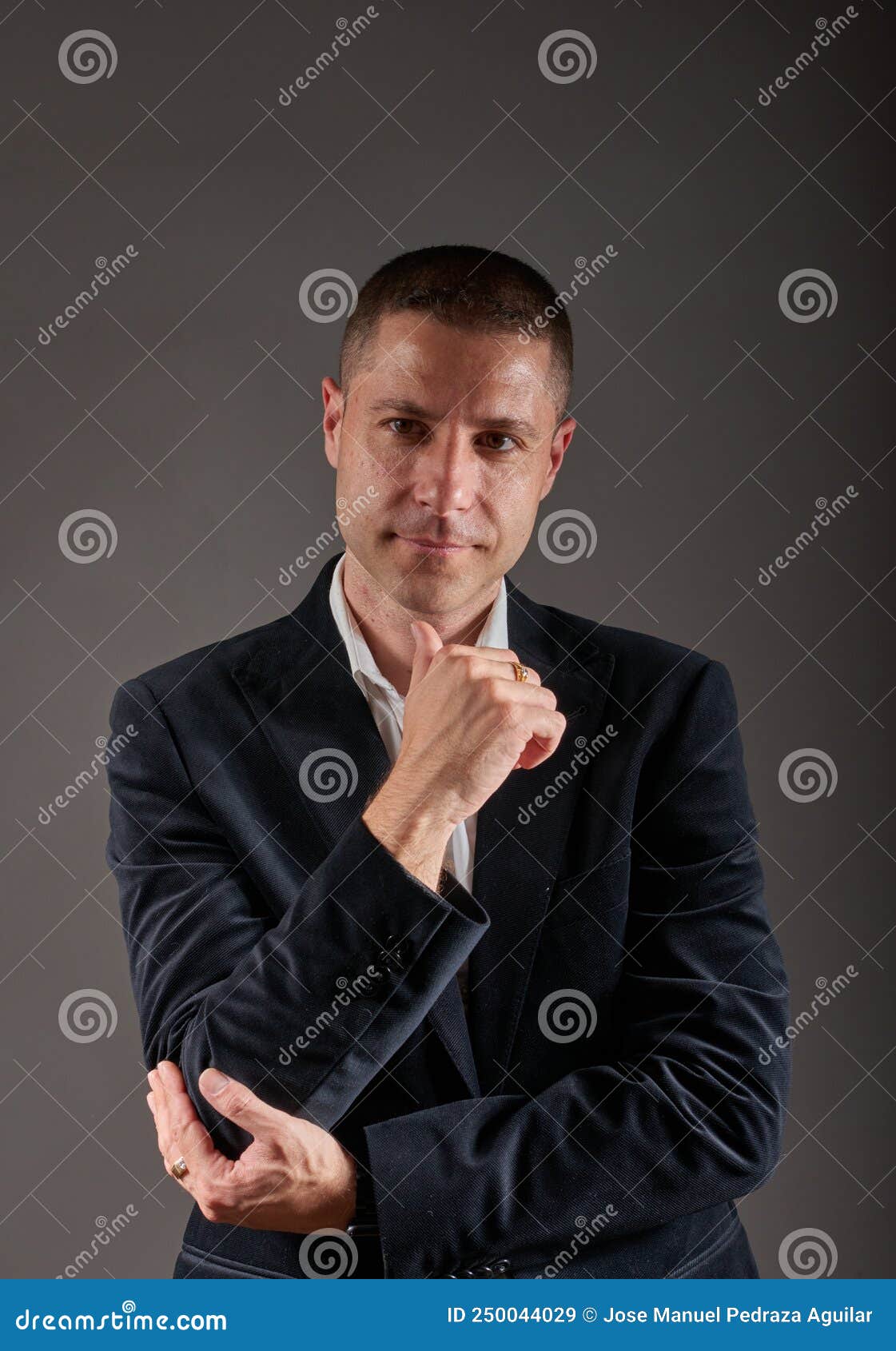 A Young Man Wearing a White Shirt and a Black Jacket Stock Image