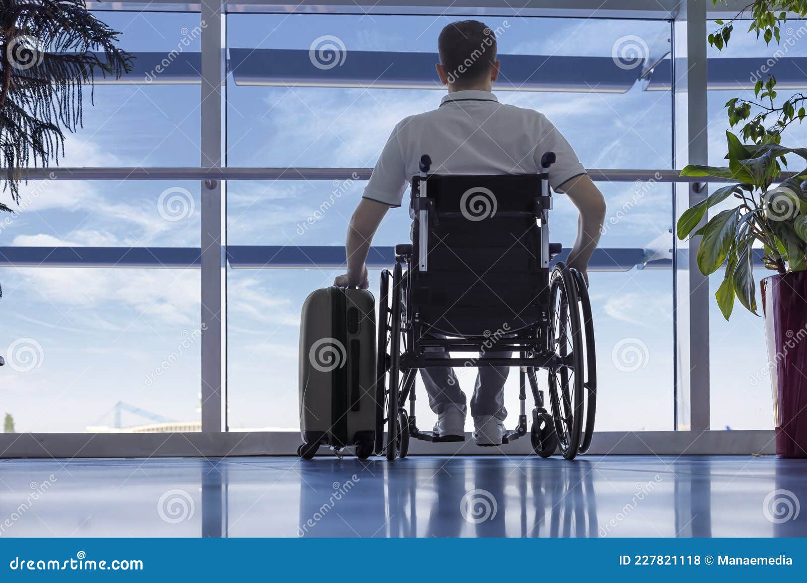 young man in a wheelchair at the airport