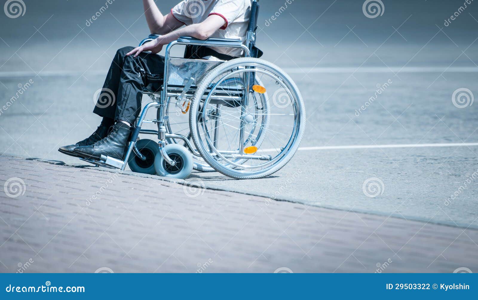 Young Man in Wheelchair on the Road Alone. Stock Photo Image of
