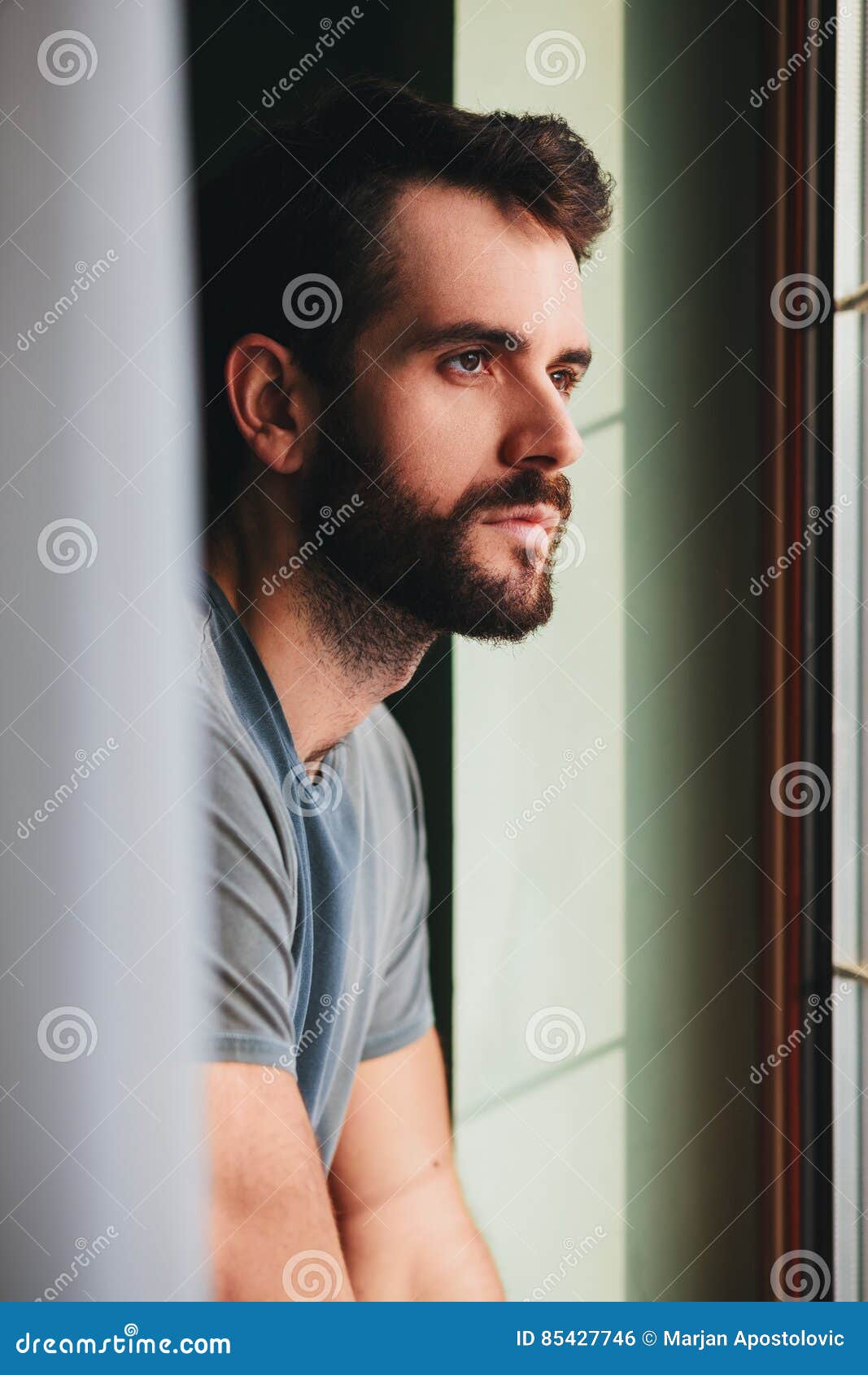 Young Man by the Window Looking Outside Stock Photo - Image of  disappointment, grief: 85427746