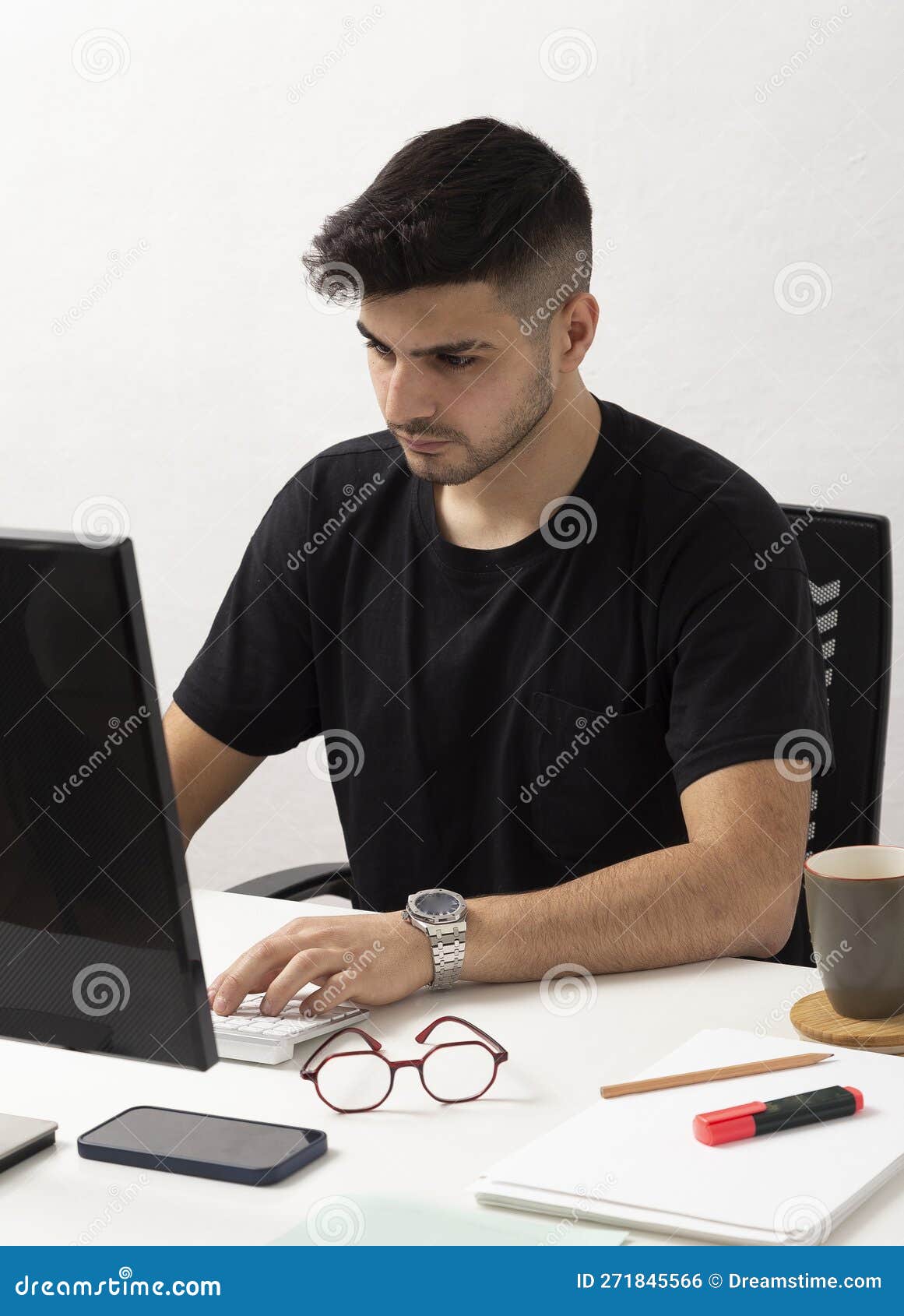 Young Man Working with Computer in His Home Office.education.business.e