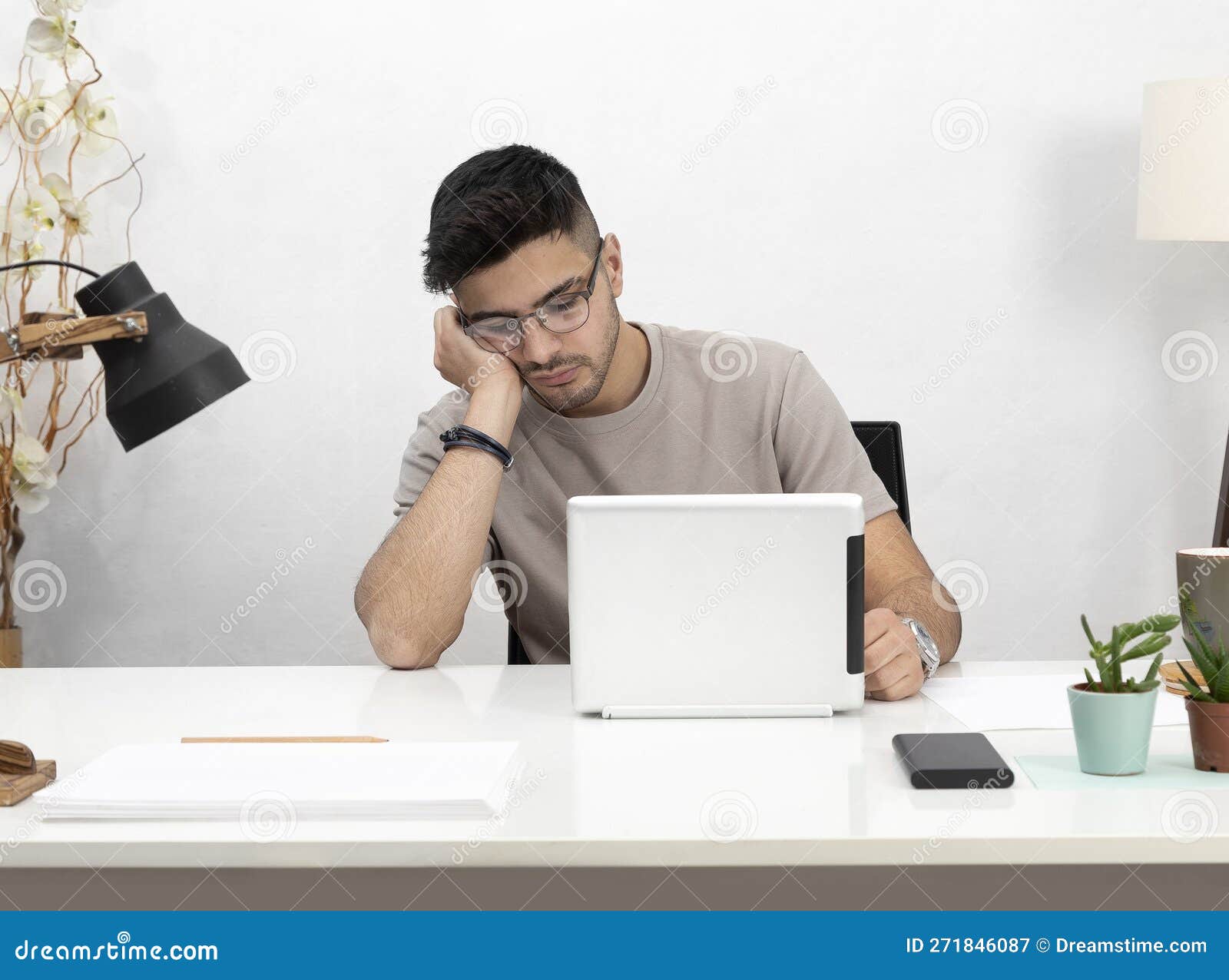 Young Man Working in Home Stock