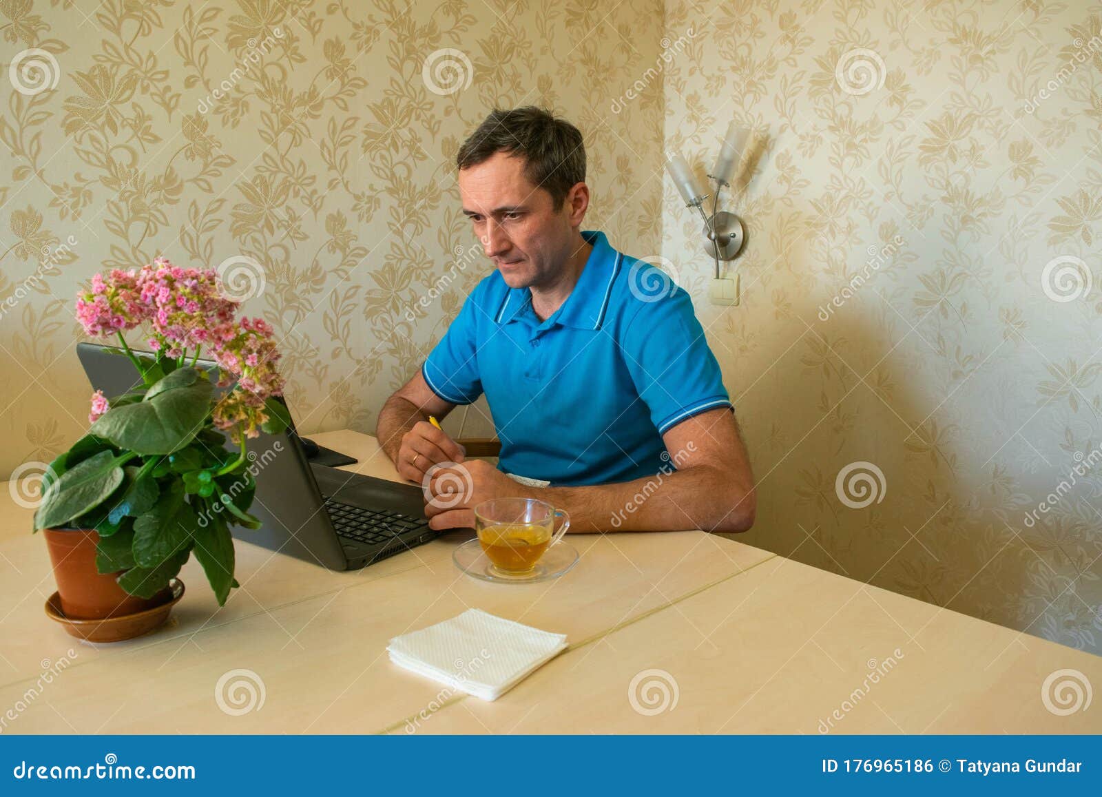 young man is working remotely at the computer without leaving home