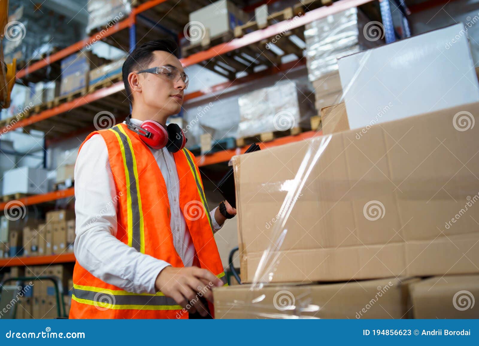 .Young Man Working in a Warehouse with Boxes. Stock Image Image of