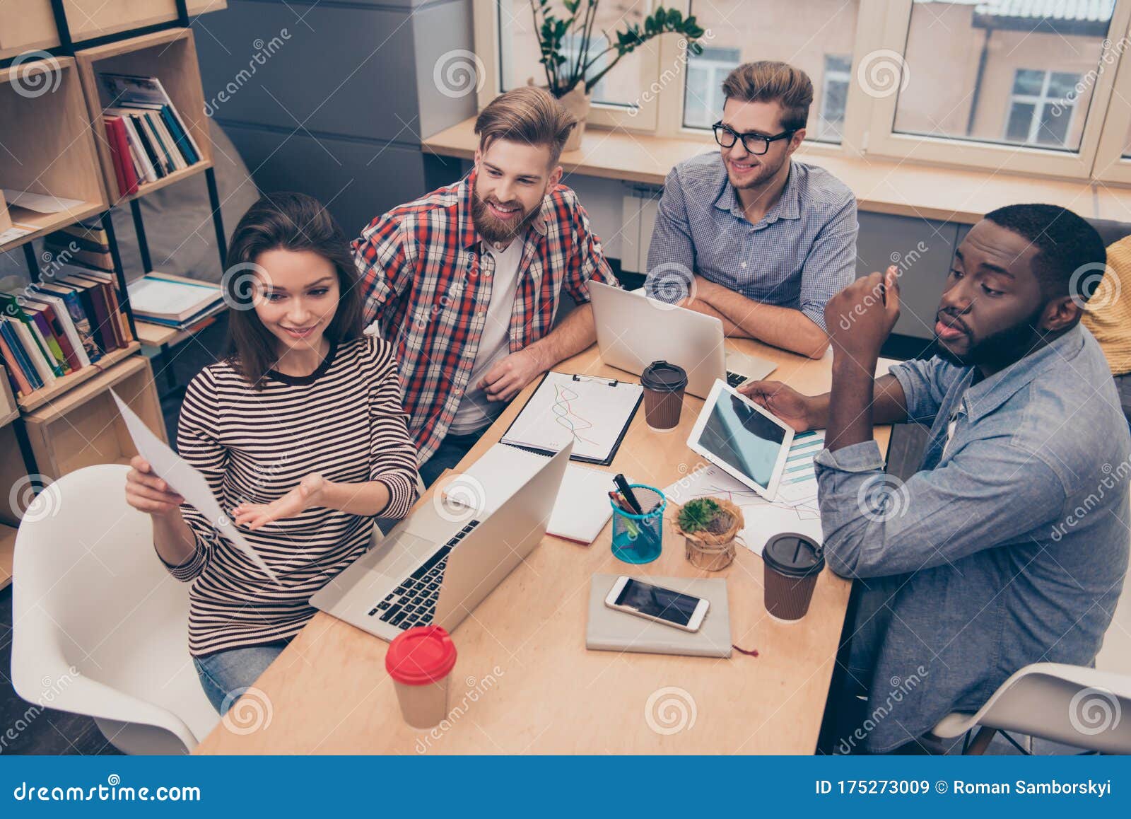 young manager woman showing document with diagrama to her colleagues