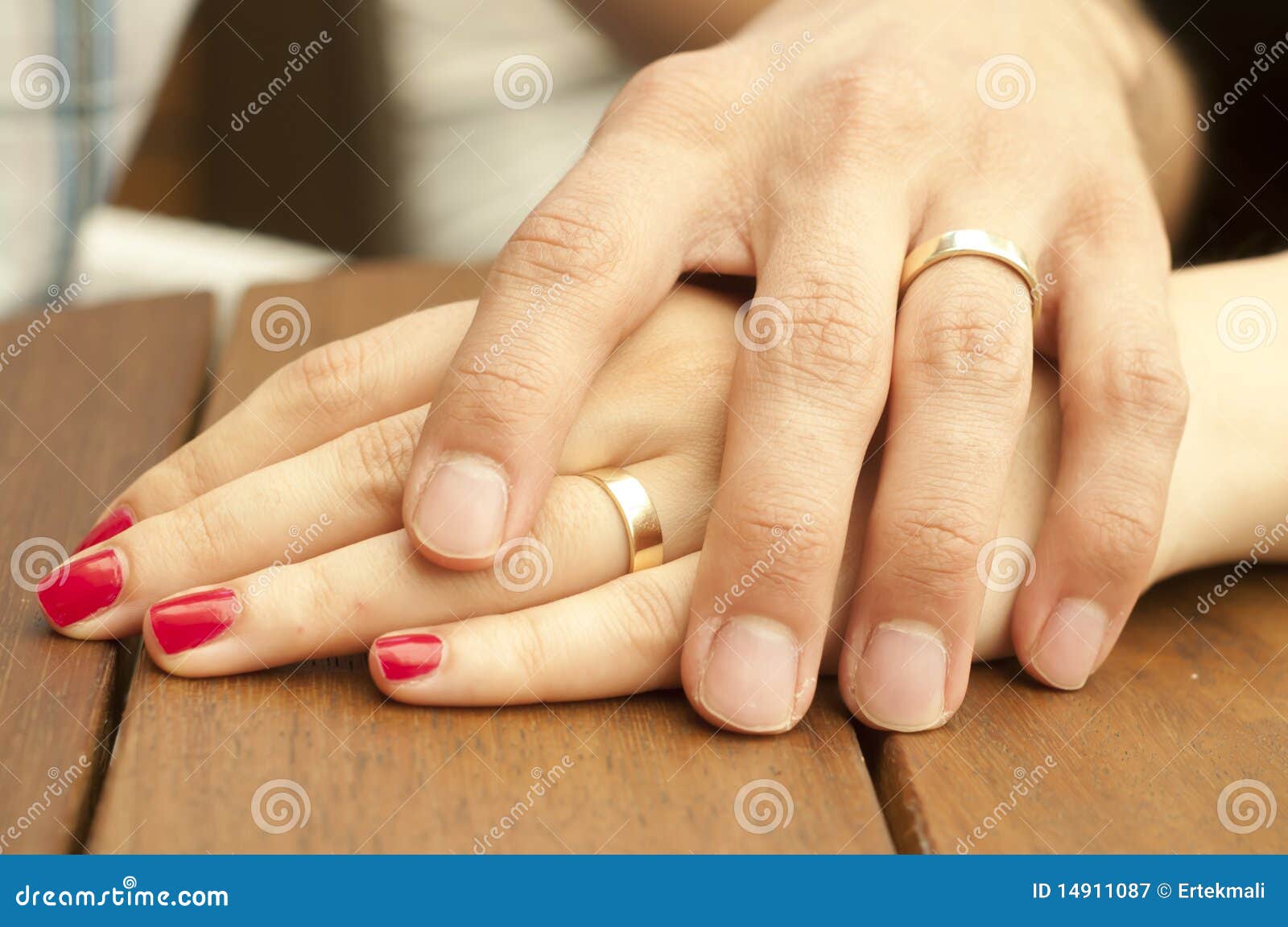young married couple holding hands closeup