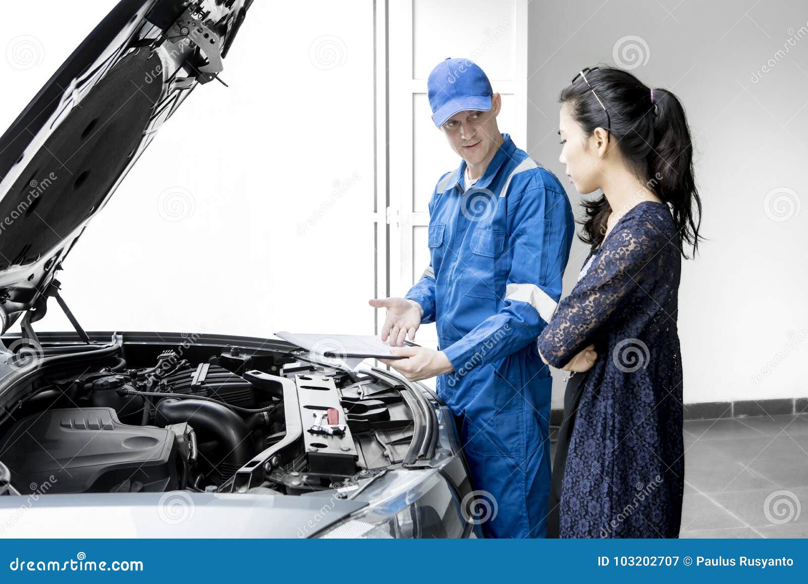 Young Mechanic Giving Repair Cost To His Client Stock Image Image of