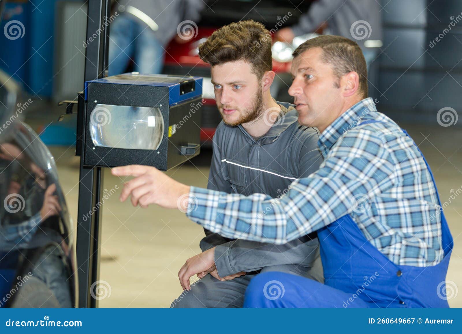 Young Mechanic Installs Tail Light on Vehicle Stock Image Image of