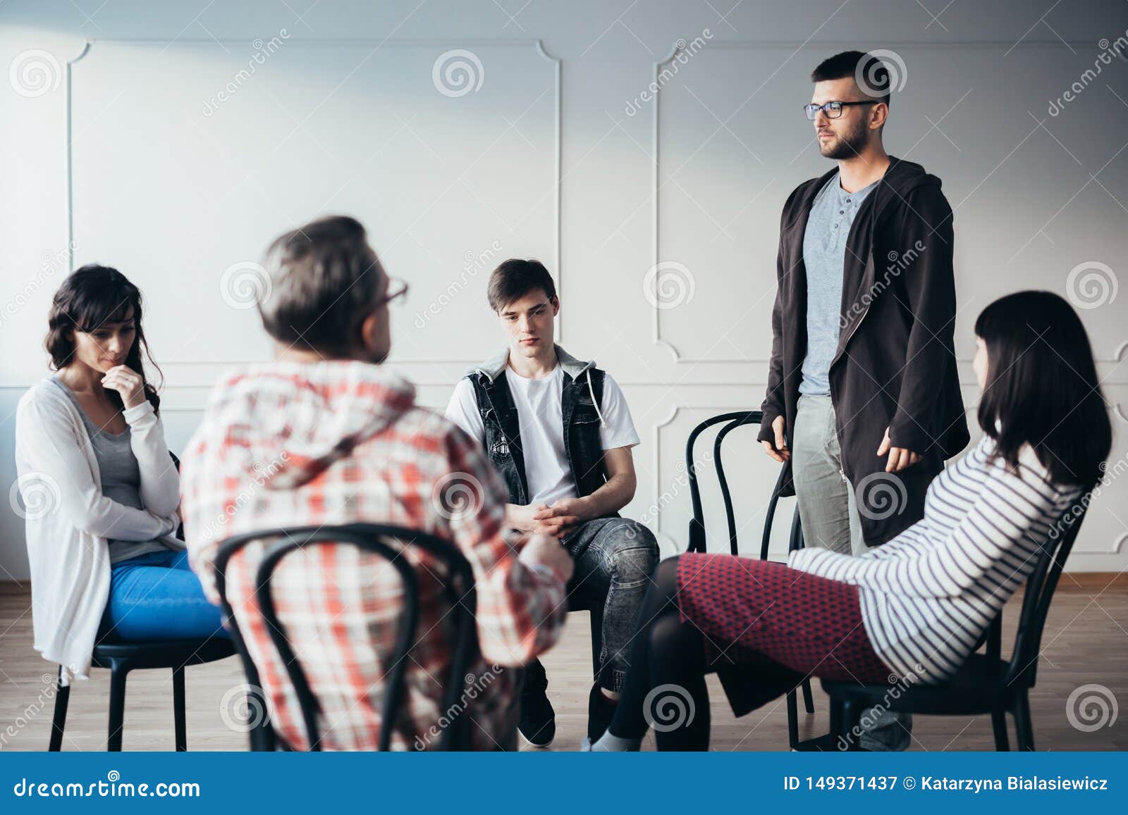 young man admitting that he is an alcoholic during support group meeting