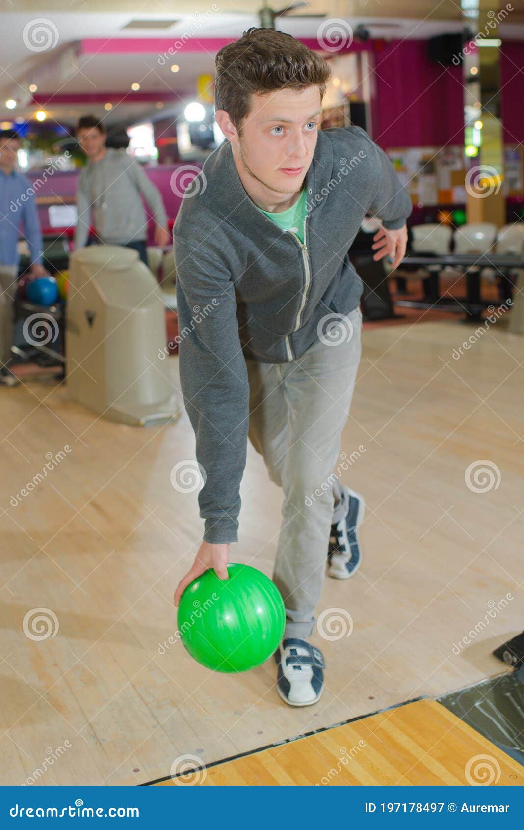 Young Man Poised To Throw Bowling Ball Stock Image Image of alley